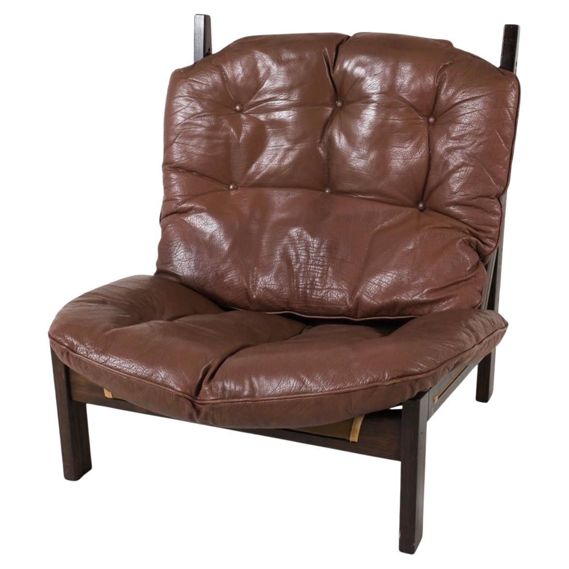 Mid century Scandinavian Modern lounge chair by Torbjørn Afdal. Solid wood frame in dark brown Stain brass hardware with brown leather cushions with canvas seat sling. Made in Norway circa 1970s. Located in Brooklyn NYC.

Dimensions: H 37