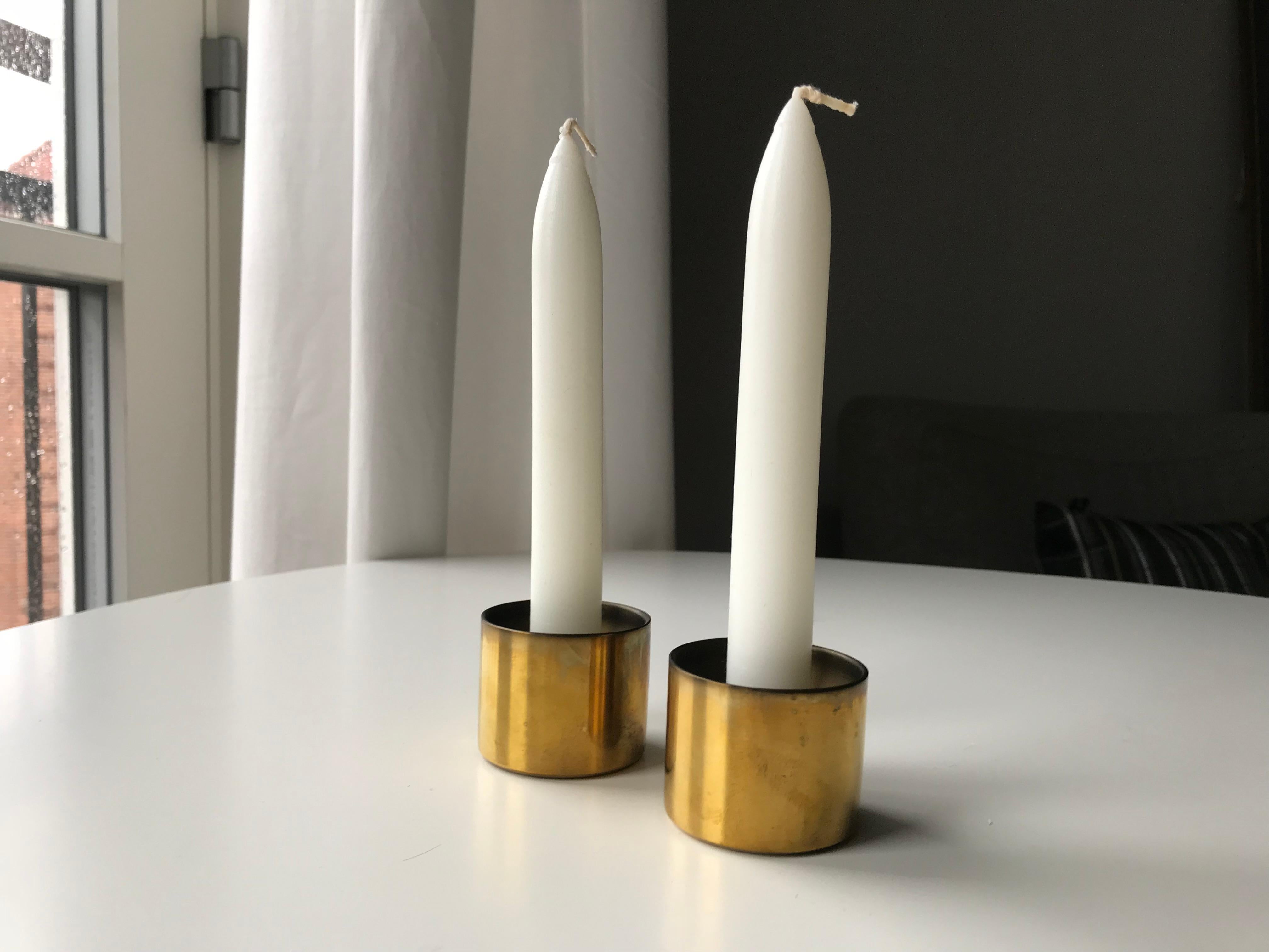 Mid-Century Scandinavian Modern Stelton Original boxed pair of chandeliers in brass. Box including original candlesticks. Discontinued from Stelton of Denmark. The most iconic and well known items from Stelton is designed by Arne Jacobsen. This set