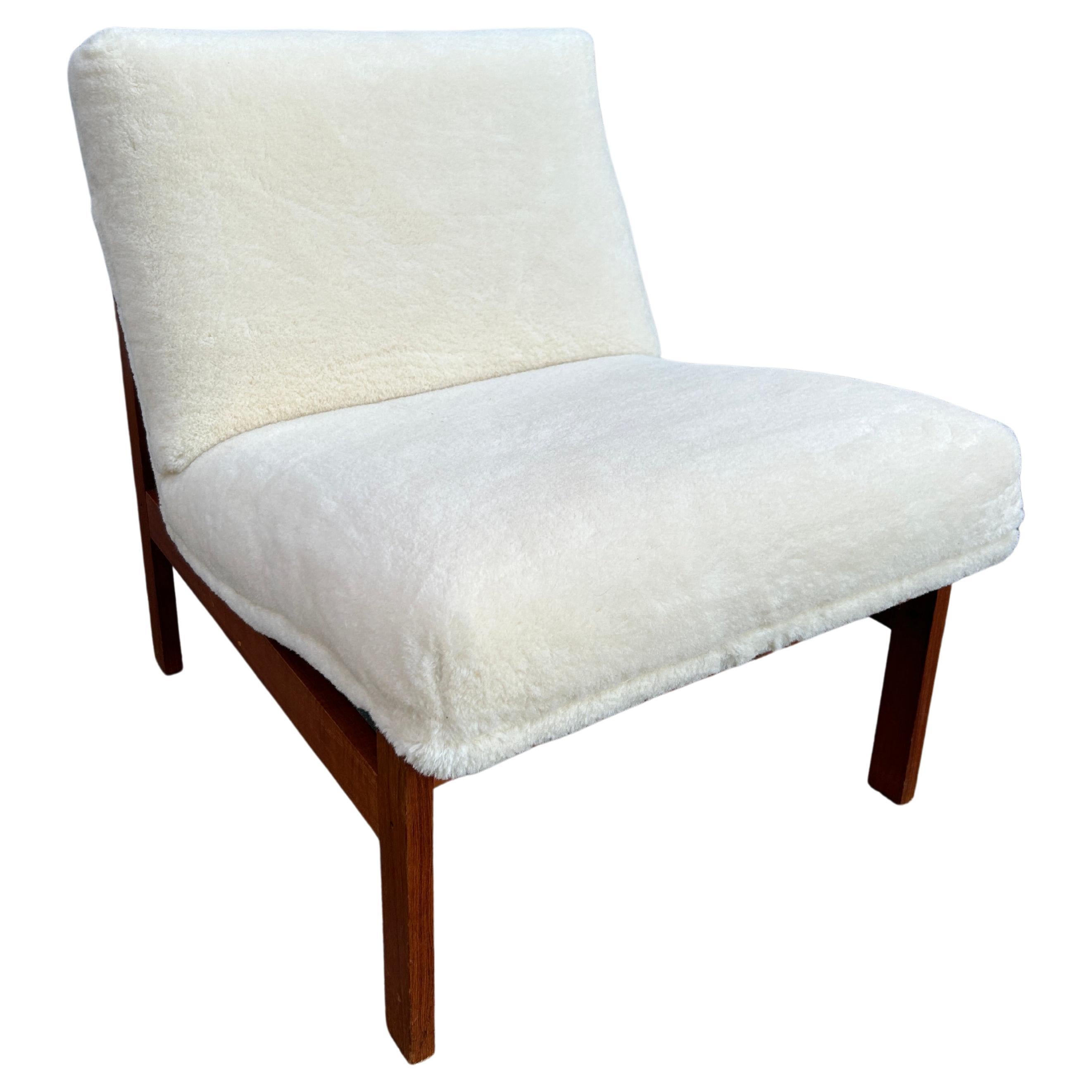 Beautiful minimalist Scandinavian Modern slipper lounge Chair by France & Son - Made in Denmark. Solid geometric teak frame with high quality joints with brand new Holly Hunt shearling wool upholstery in white. This chair was fully restored in Holly