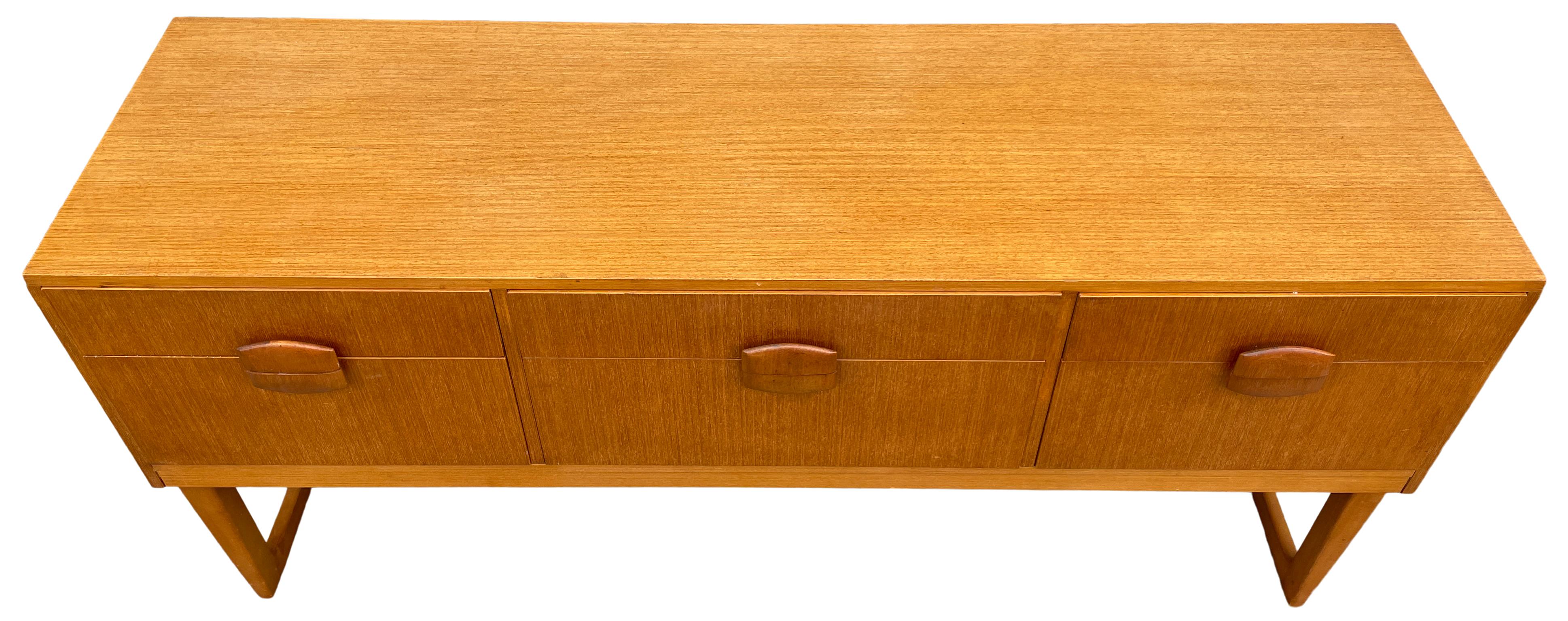Mid Century Scandinavian Modern Teak Low 6 drawer credenza dresser. Beautiful designed Low Dresser or Credenza in the style of Børge Mogensen - Light teak wood Veneer with sculpted handles. Sits high on a pair of U shaped legs. Clean Inside and out.