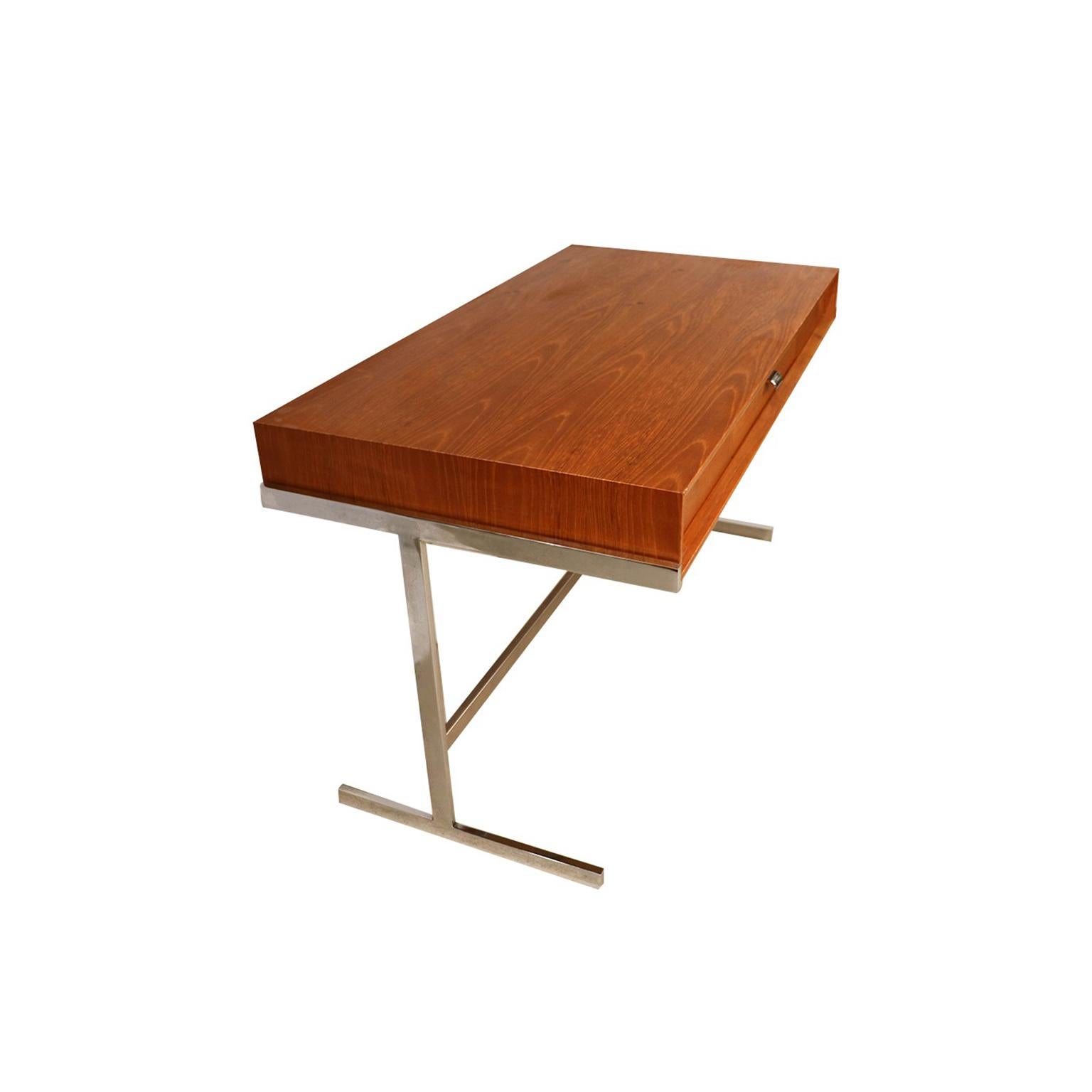 Sophisticated Mid-Century Modern trestle base desk by Royal Board, Sweden, 1960s. Featuring a beautiful teak case resting on a striking and unique polished stainless-steel trestle base with foot rail, creating a stunning contrast of textures. A