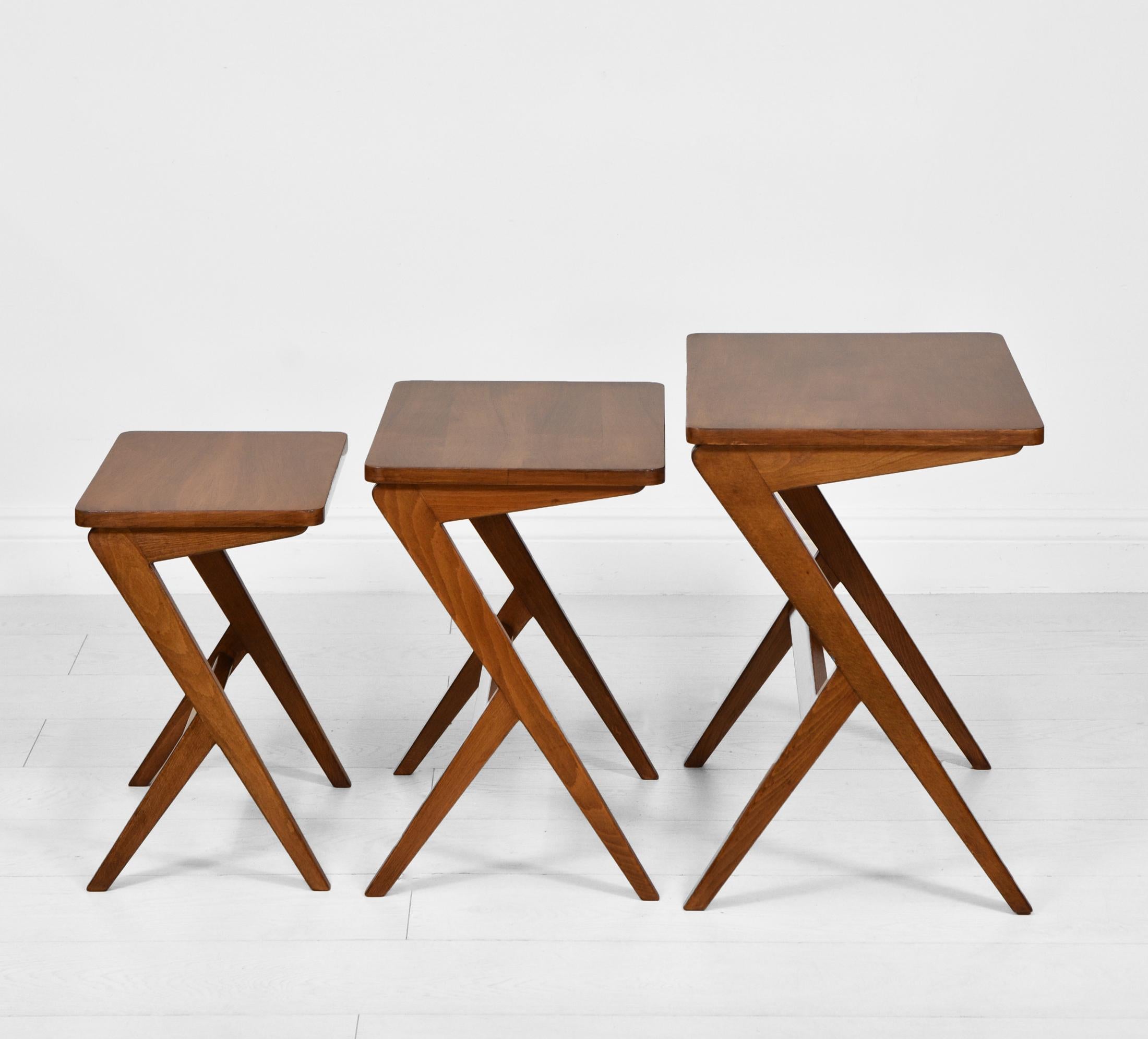 A striking nest of walnut and beechwood tables designed by Swedish architect and furniture designer Bengt Ruda. Circa 1950s.

Ruda's design style was highly influenced by Italian designers. These sleekly lined tables have been re-finished in a