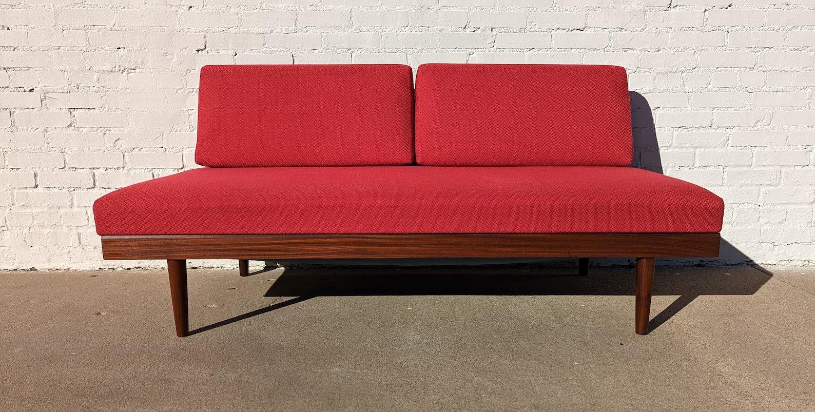Mid Century Scandinavian Red Sleeper Sectional

Above average vintage condition and structurally sound. Has some expected slight finish wear and scratching on teak frame. Upholstery is new. Has a couple edge chips in teak frame. Both sofas pull up
