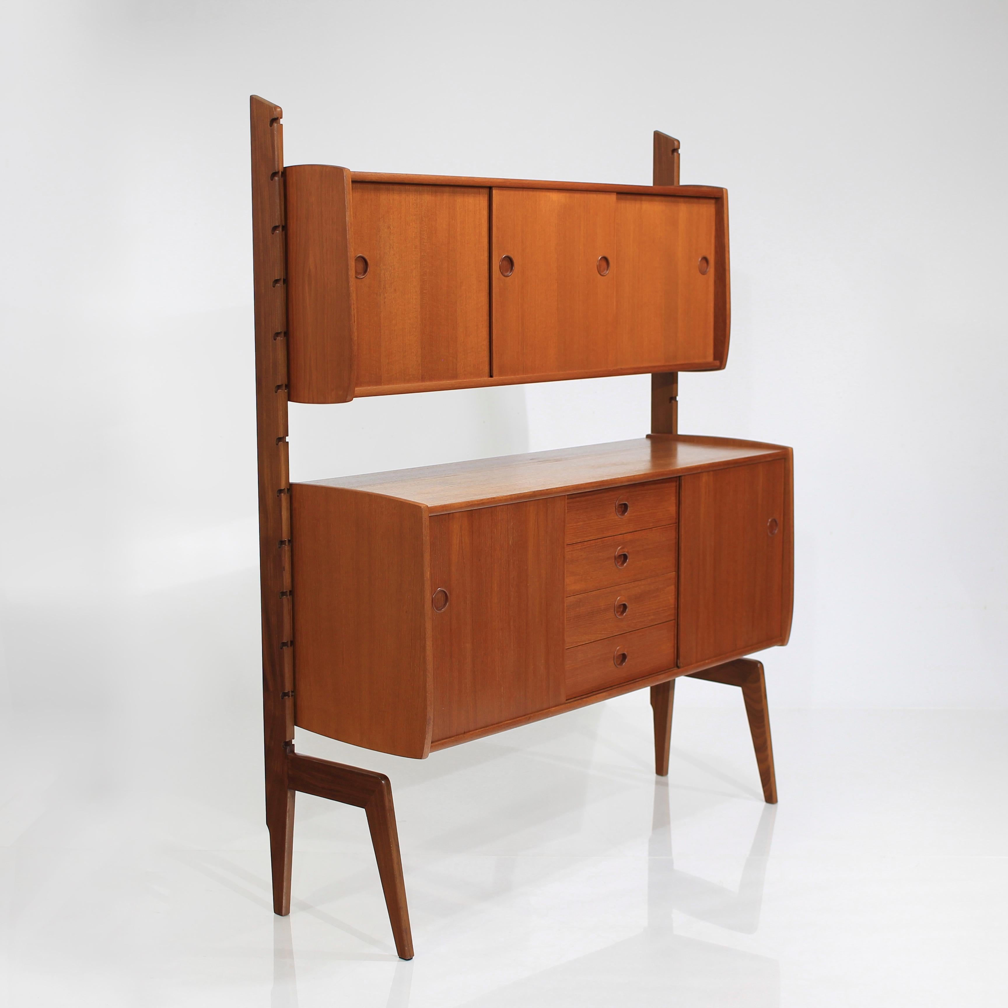 About this vintage free standing mid century Scandinavian bookcase:

This Teak Freestanding Ergo wall unit by John Texmon and Einar Blindheim for Blindheim Møbelfabrik is such a versatile piece.

With it's striking design and aged teak wood,