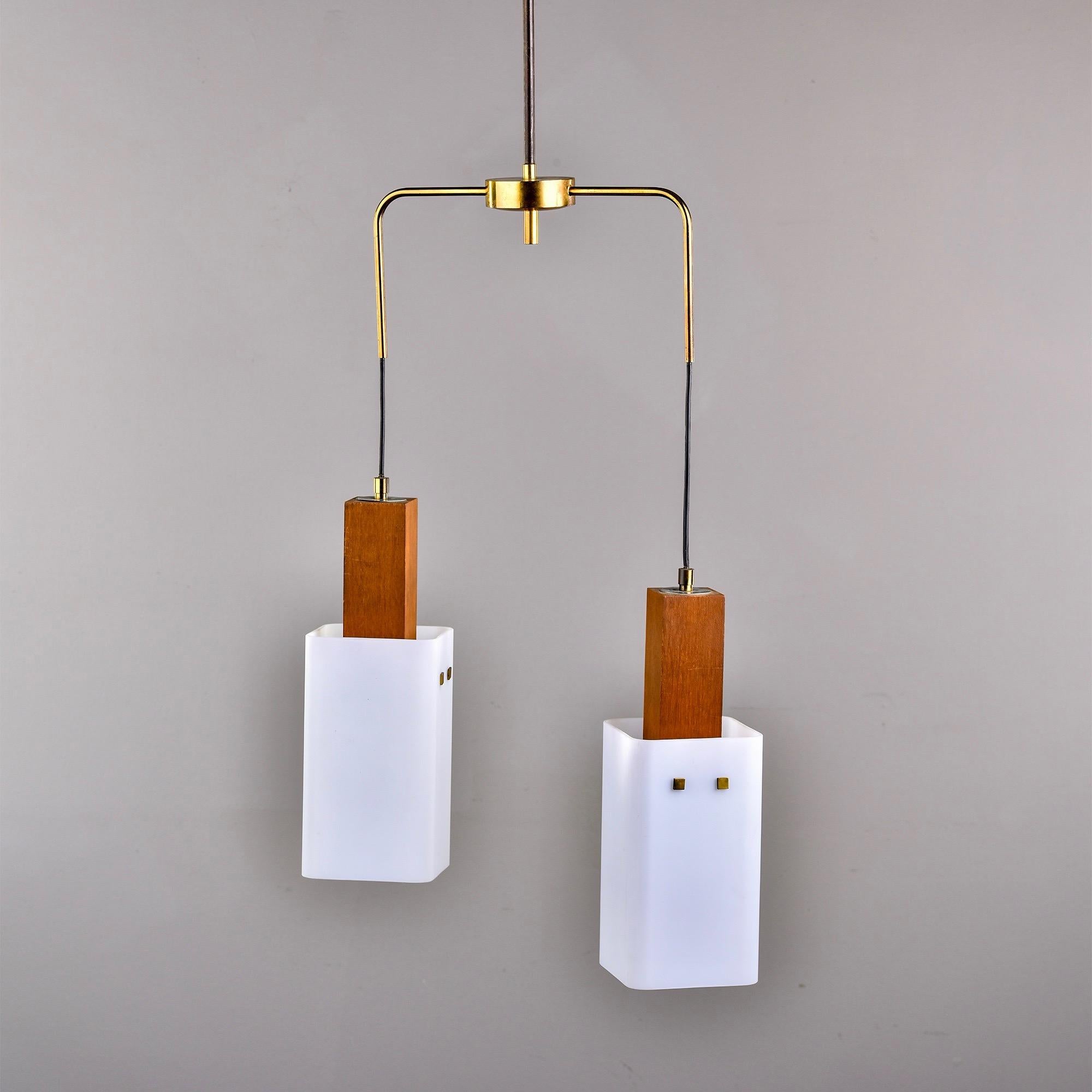 Circa 1960s two light hanging Scandinavian light fixture with rectangular white glass globes, teak bodies and a brass frame. Unknown maker. New wiring for US electrical standards. 

Measures: Fixture only: 5” H x 5” W x 5” D
Frame: 18” H x 12.5”