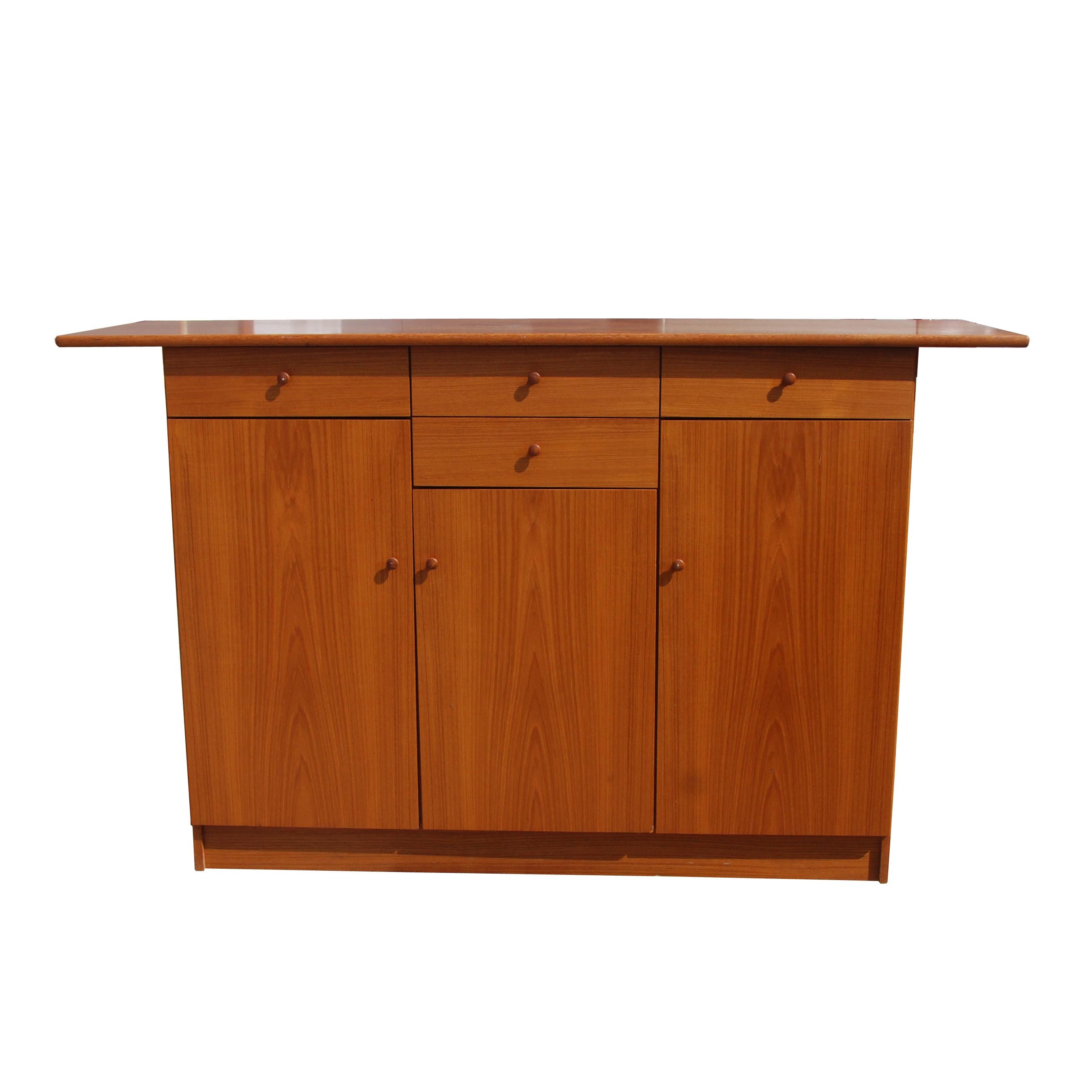 Midcentury Scandinavian teak buffet

Four spacious drawers for flatware
Three cabinets with four individual shelves

Measures: 65