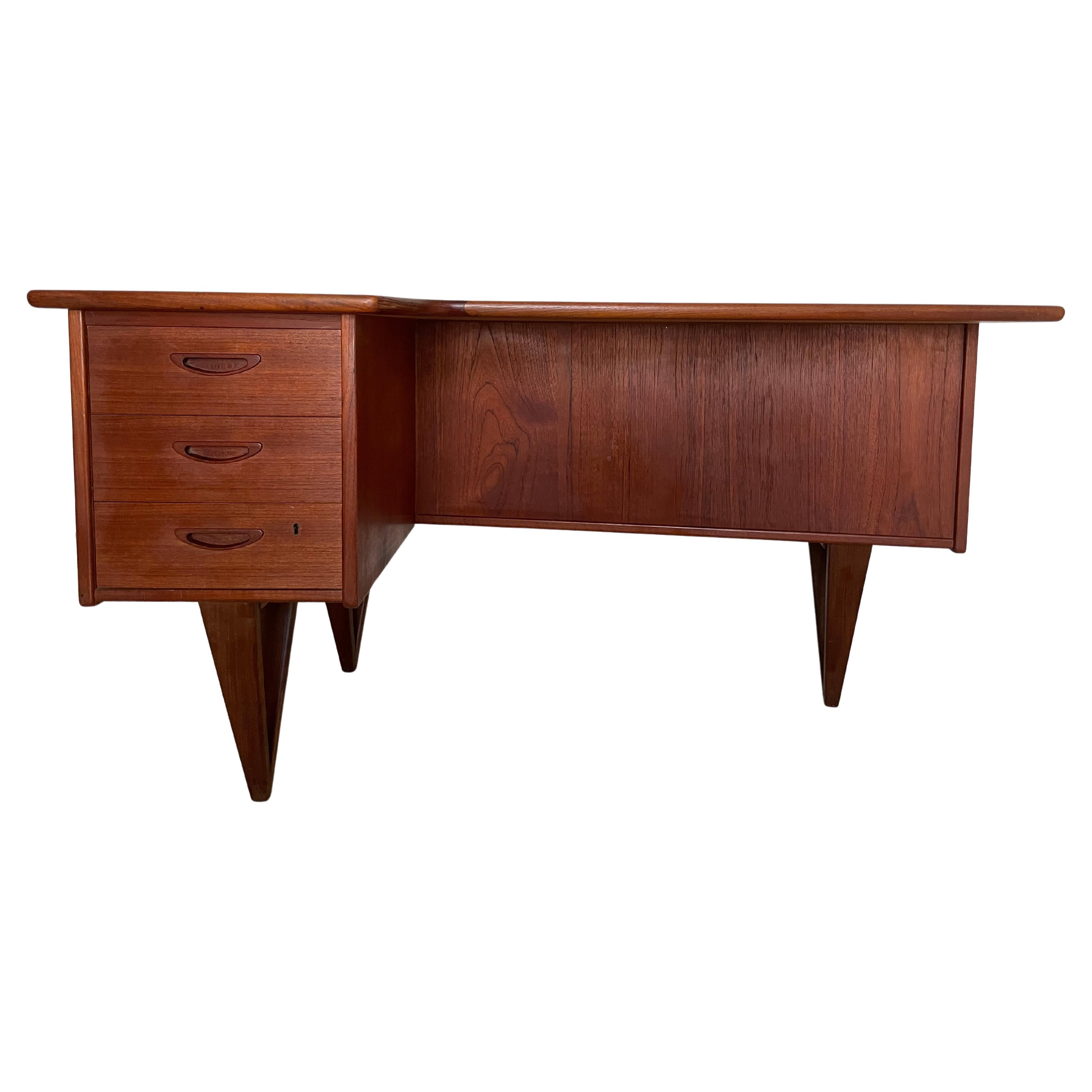 Desk designed by Göran Strand for Lelångs Möbelfabrik in Sweden in the early 1960s.
This model in teak wood has a very particular shape of the top, deeper on the left side where there are three drawers with handles carved in solid wood, the first