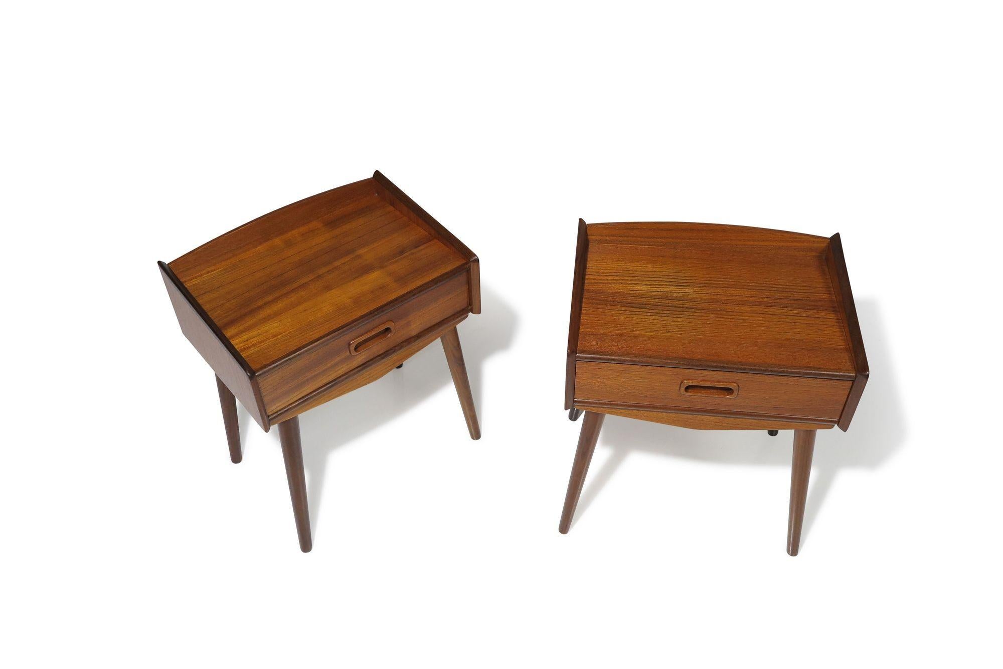 Danish teak nightstands by Uhrhøj Møbelfabrik, 1962, Denmark. These nightstands are crafted from teak and feature a single drawer with carved pulls, elegantly raised on flared tapered teak legs. The cabinets have undergone a full restoration,