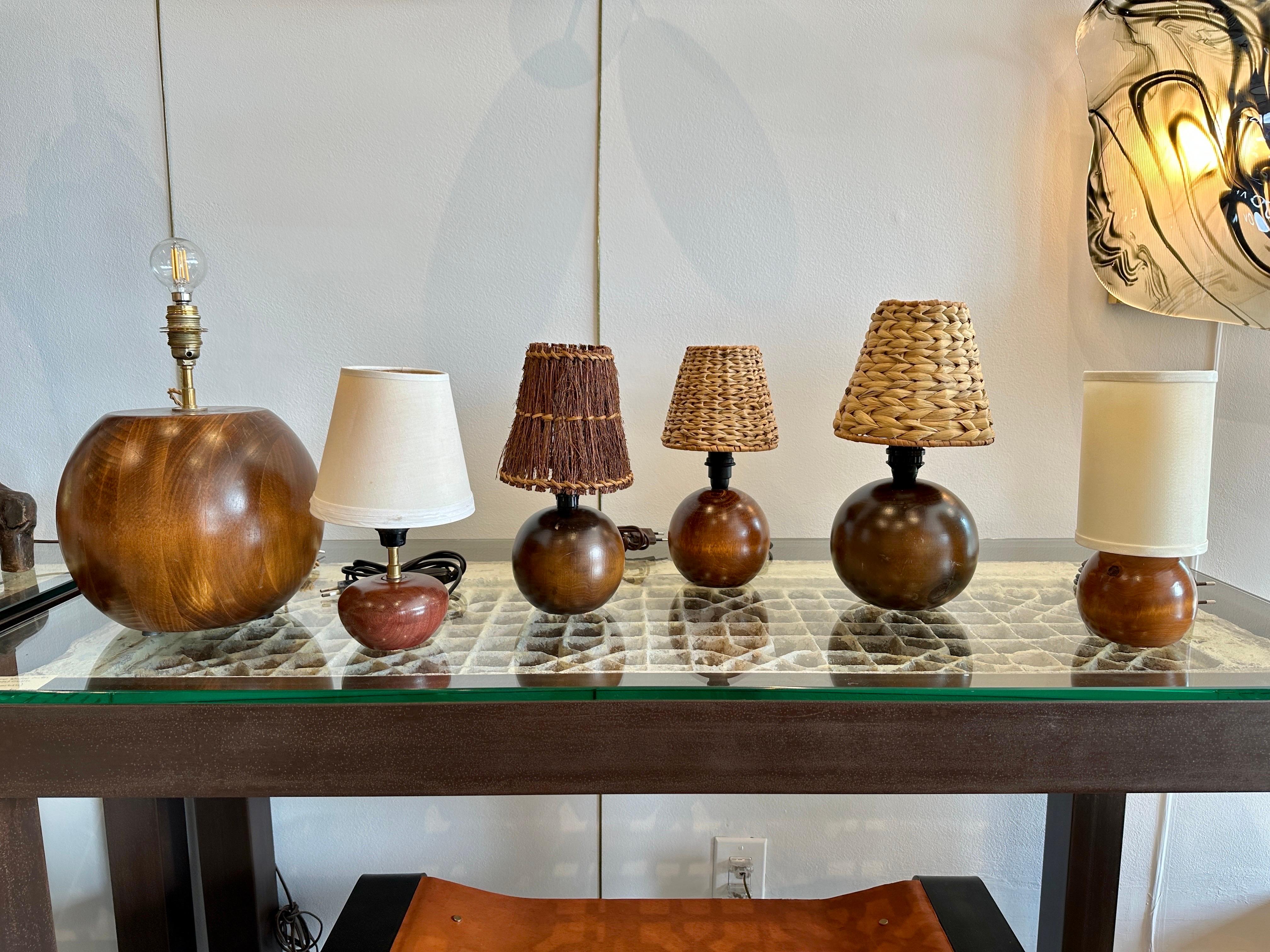 This globe form teak lamp is comprised of a solid chunk of teak wood formed by Scandinavian craftsmen to create this amazingly organic lamp. NOTE: there is an amazing grouping of these in varying sizes and varying shades - SEE DETAIL IMAGES. They