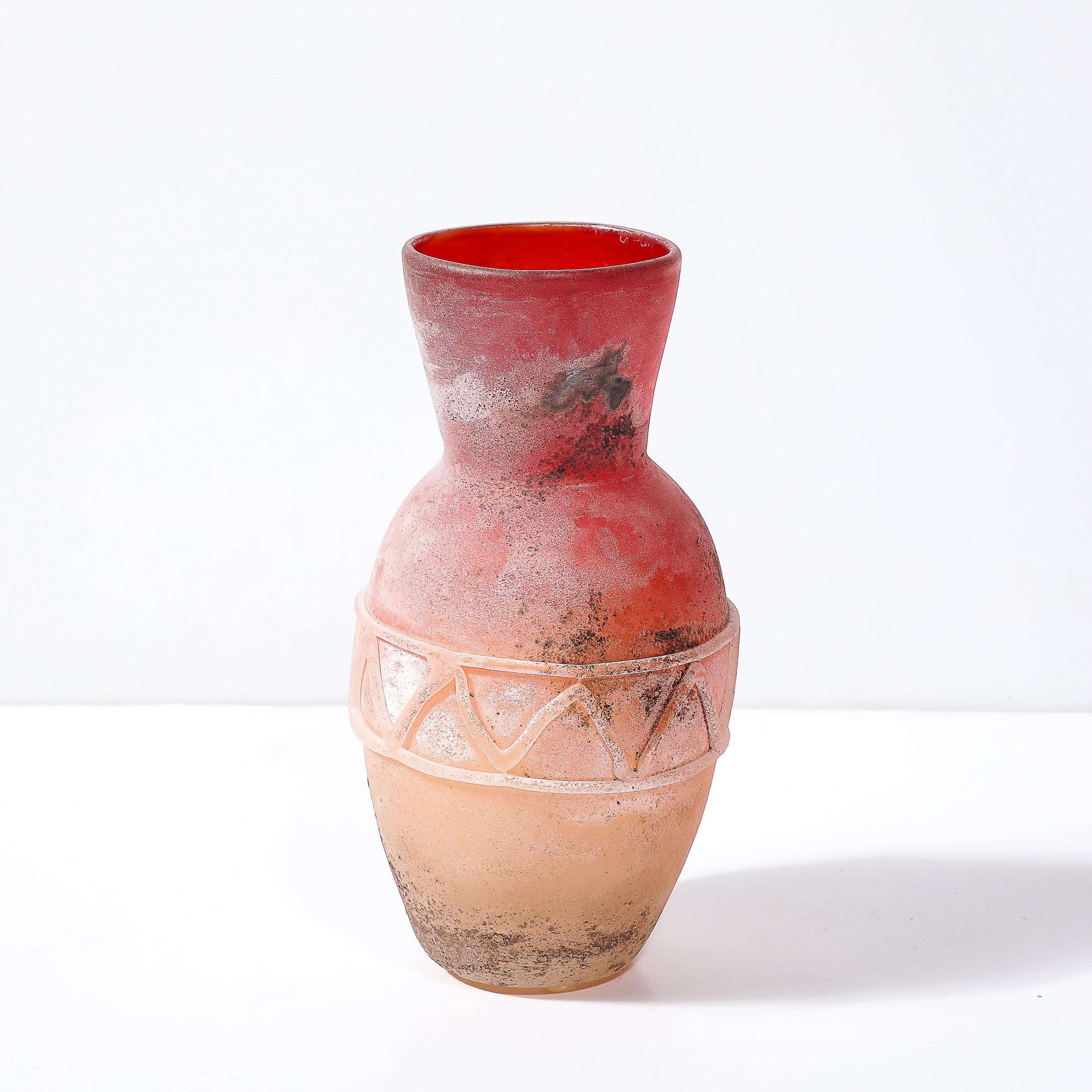 This unique and stunningly made Mid-Century Modernist Scavo Orange and Red Hued Volcanic Hand-Blown Murano Glass Vase by Ermanno Nason for Cenedese originates from Italy, Circa 1985. This piece features a classical form with a zig-zag banded pattern