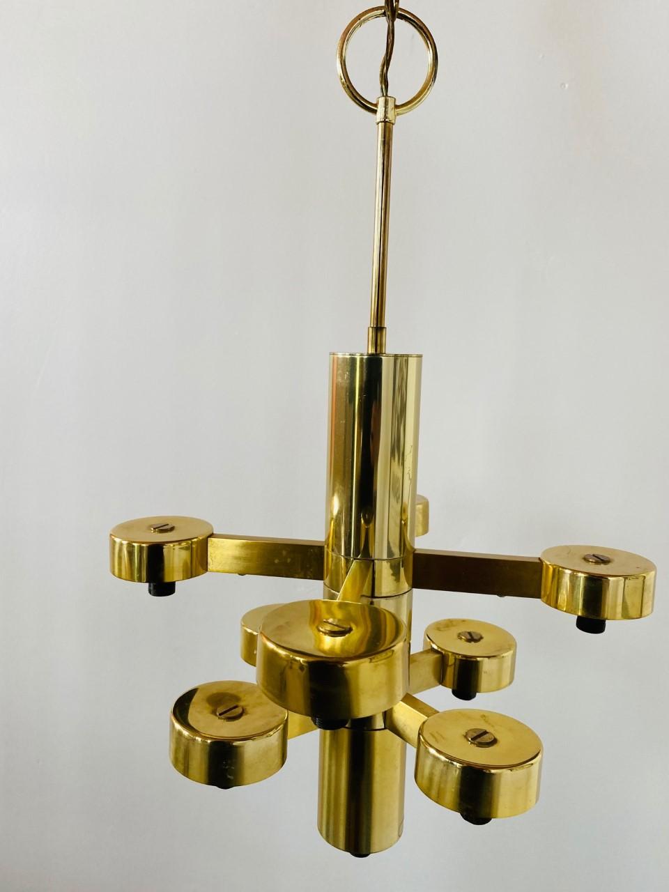 Vintage Gaetano Sciolari chandelier by Lightolier. A mid-century original, this piece is glamourous and sculptural. The piece has multiple levels of frosted glass cubes on a brass structure. Designed in Italy in the 1970s, this piece is in great