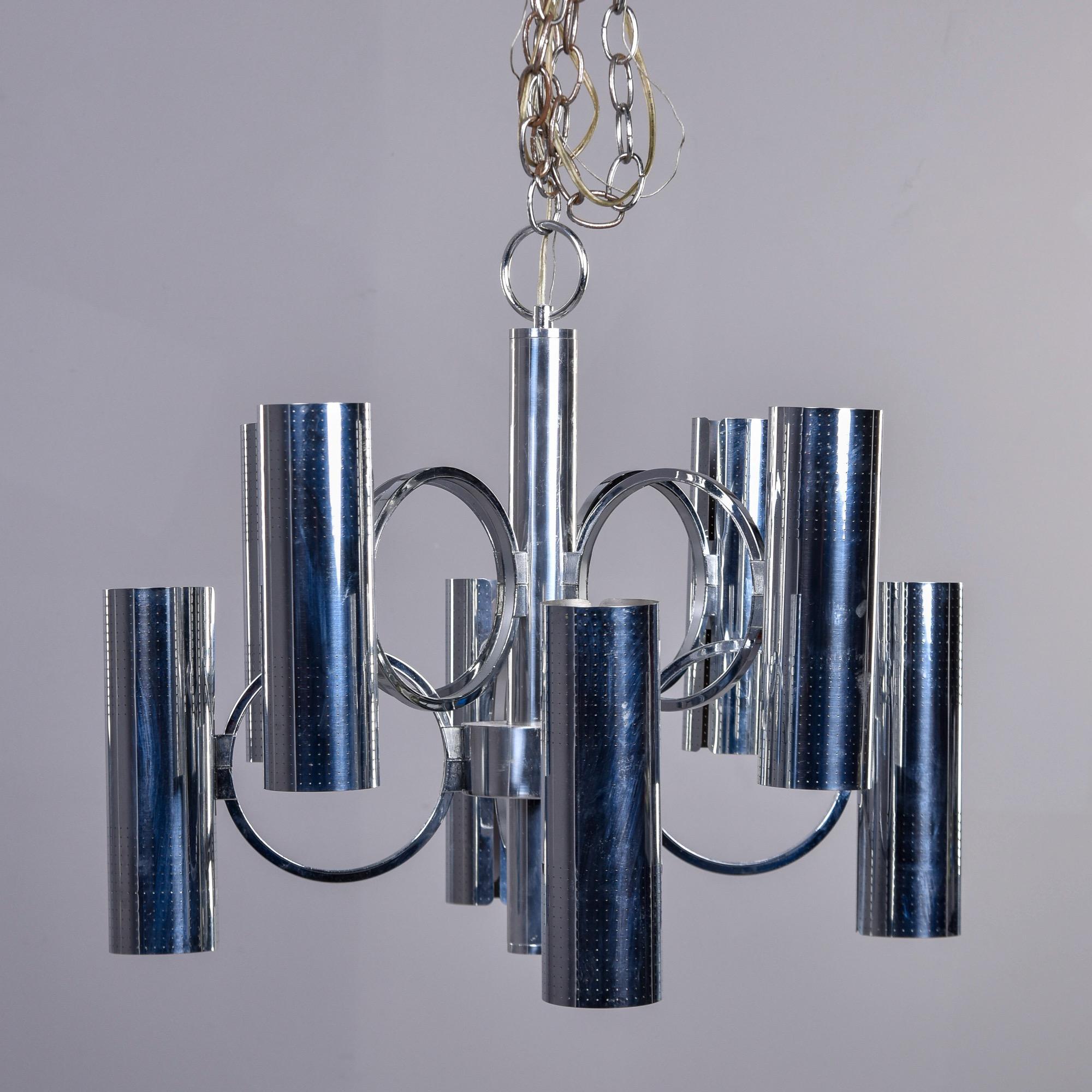 Circa 1970s chandelier in chrome by Italian designer Gaetano Sciolari for Lightolier. Each of this fixture’s eight arms has an uplight and downlight and standard sized sockets for a total of 16 lights. The chrome shades are pierced and attached to