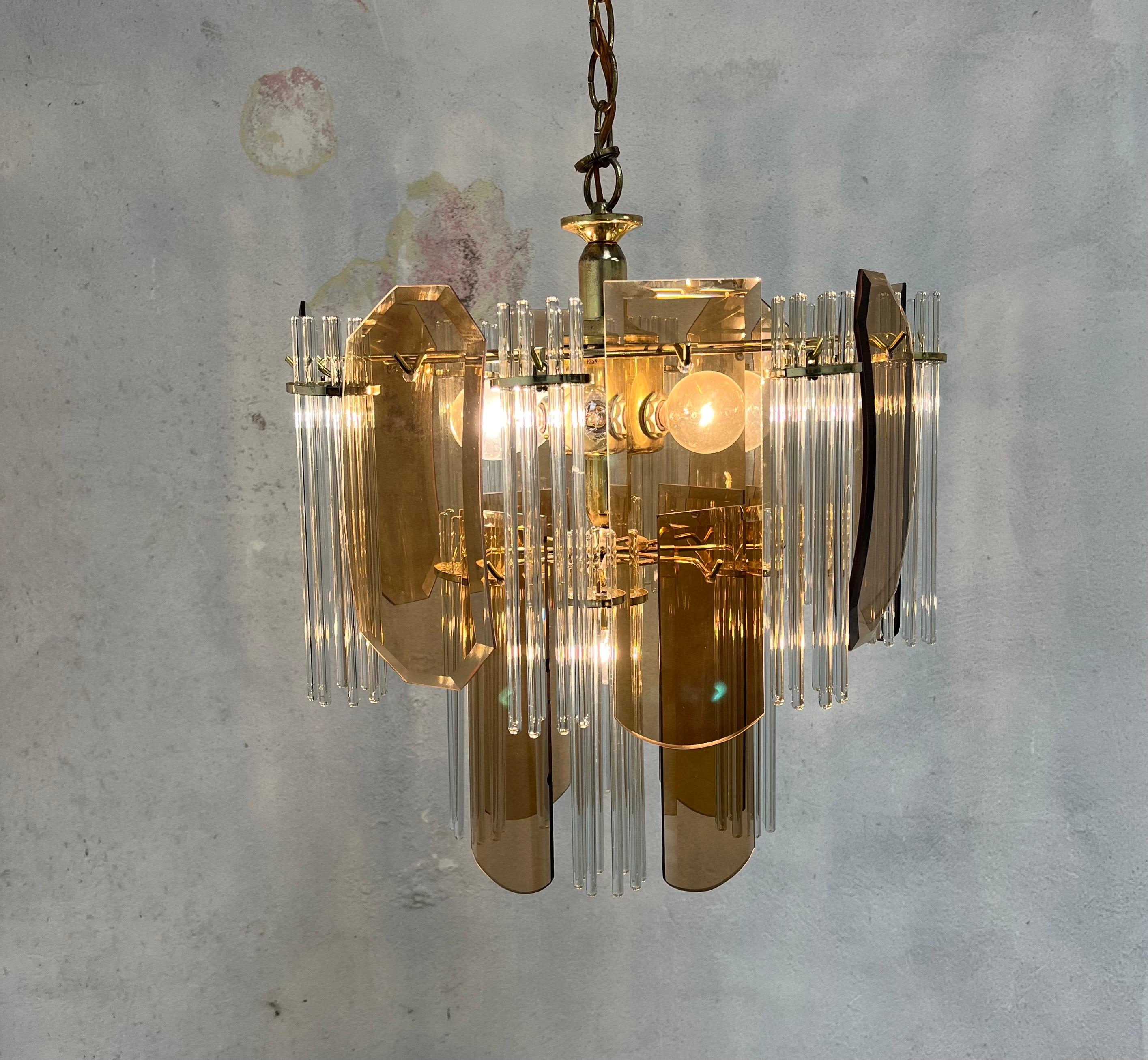 Beautiful brown glass panel and glass rod swag lamp. Alternating panels and rods create a unique visual nicely casting light. Panels vary with some bowed and others flat. 