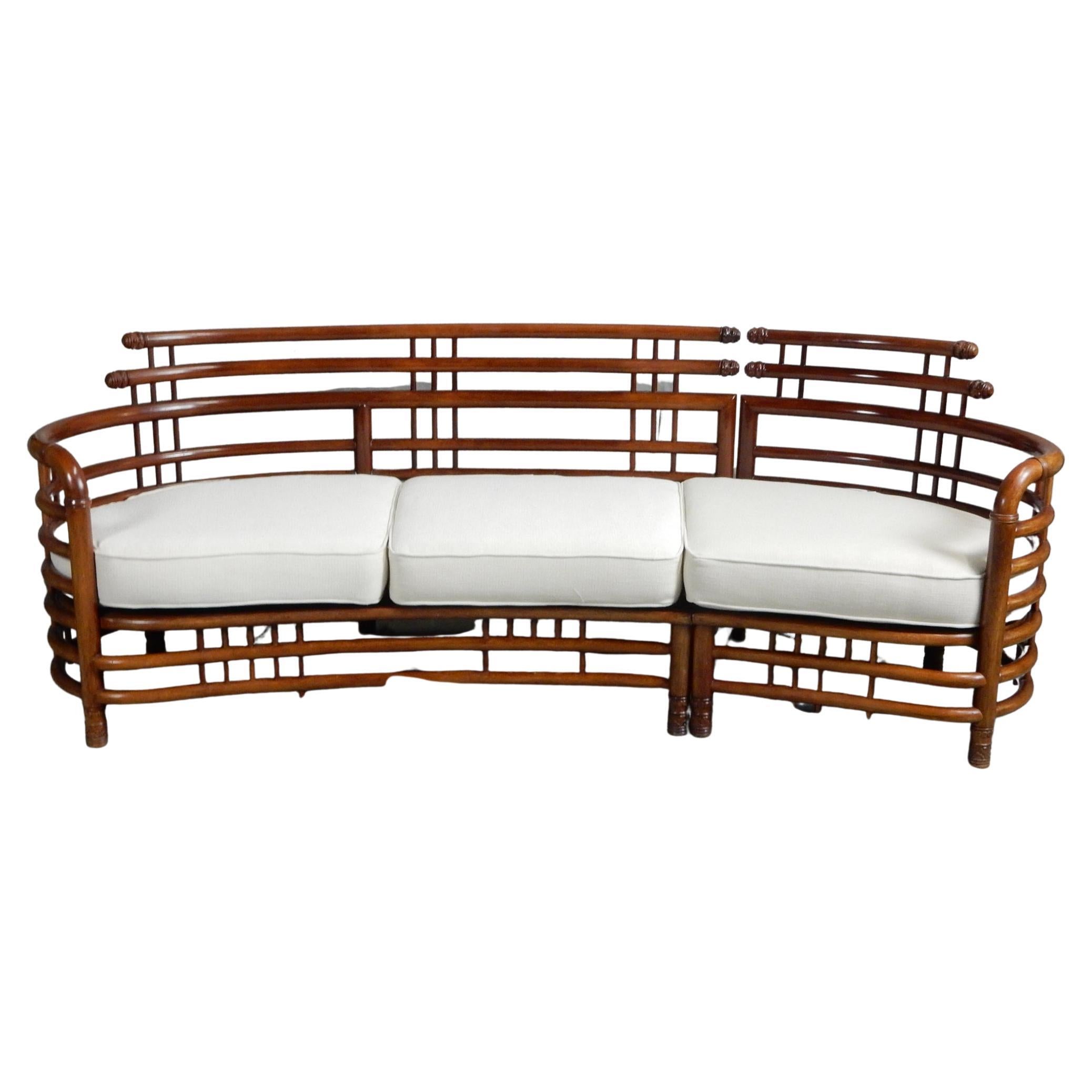 Aesthetically pleasing sculpted Teakwood birdcage sofa.
Circa 1950's, South Asia. Heavy and well crafted piece of furniture.
Newly upholstered cushions. No damage or repairs.
Bolts together under the left side allowing it be 2 separate pieces.
This