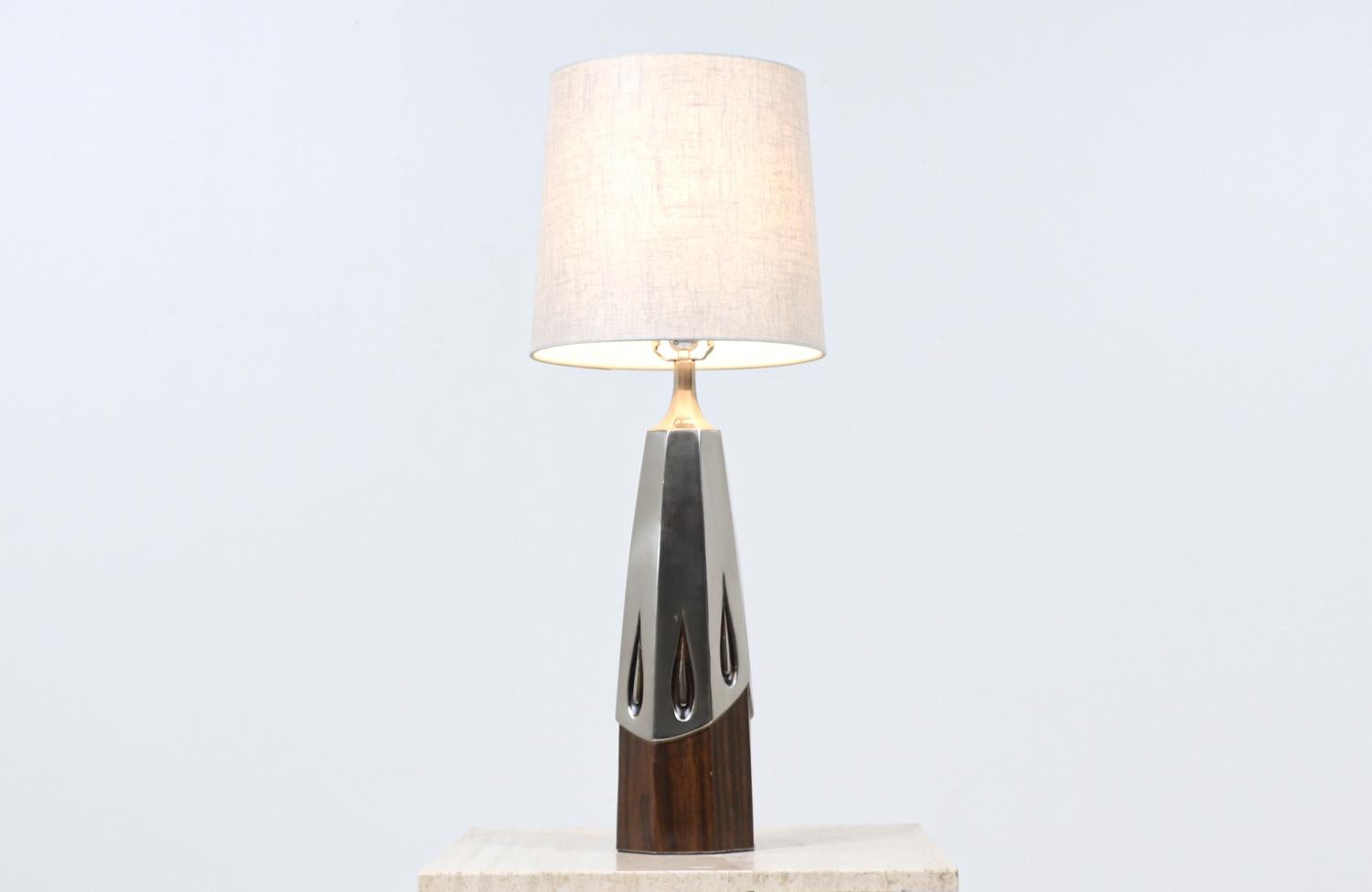 Materials
Patinated metal, faux wood, new shade

Dimensions
32in H x 5.50in W x 5.50in D
Lamp shade: 11.50in H x 10.50in - 12in W.
 
________________________________________

Transforming a piece of Mid-Century Modern furniture is like bringing