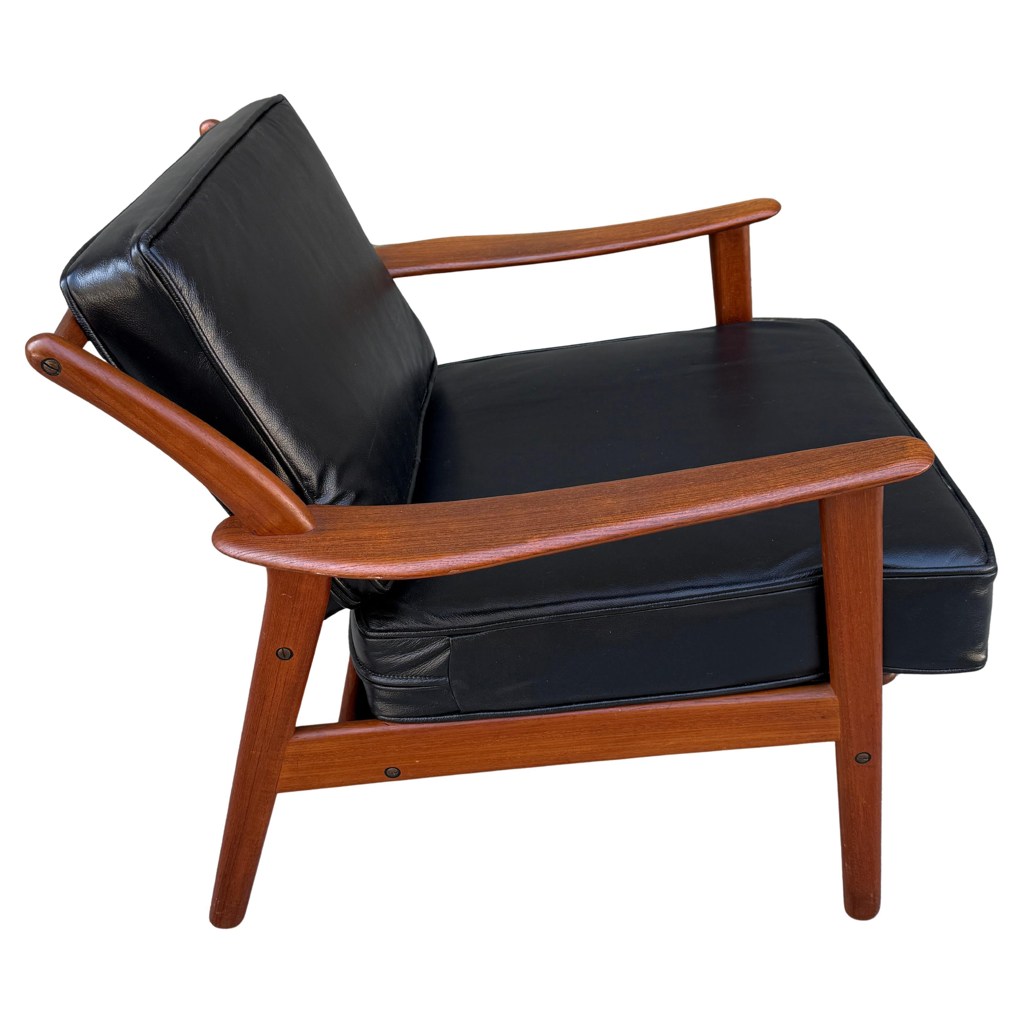 Scandinavian Modern solid teak lounge chair by Niels Koefoed with new black leather upholstery. Sleek sculptural back and gentle curves combined with angular frame creates a dynamic look.  Frame is in great original condition. Very comfortable.