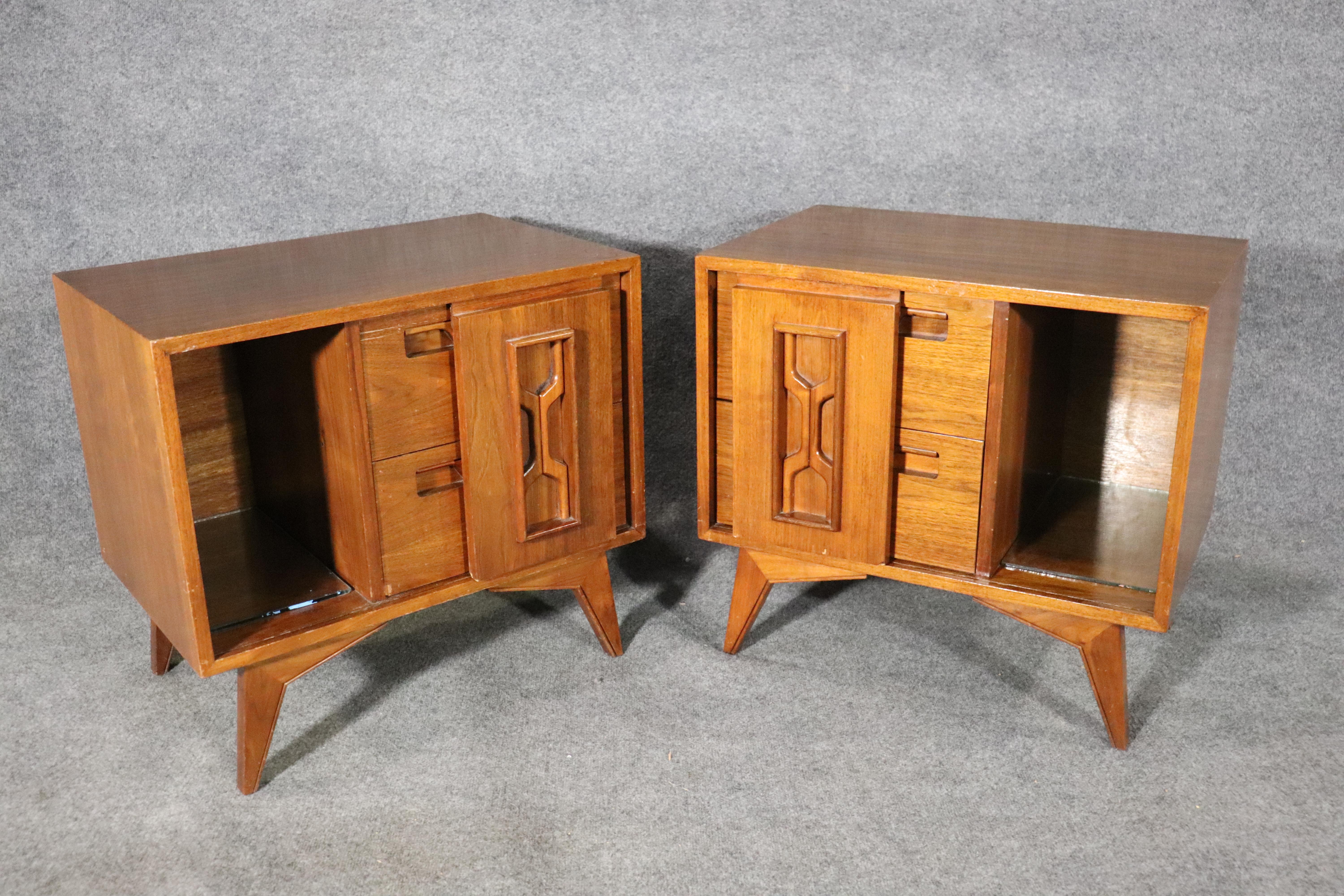 Pair of mid-century end tables with sculpted fronts. Sliding door cabinet and two drawers for bedside storage.
Please confirm location.