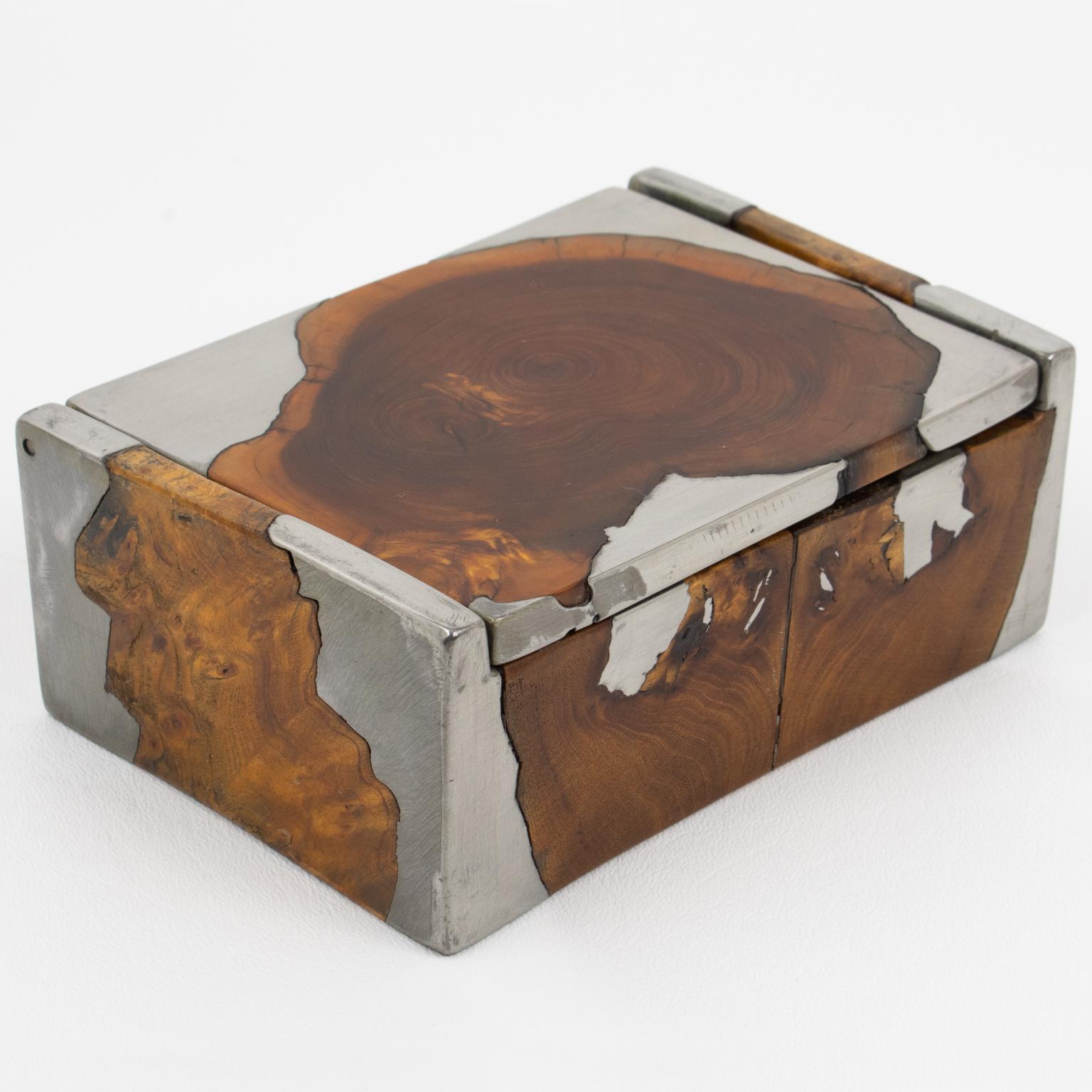 This very unusual brutalist-lidded box was hand-crafted in France in the 1960s. The piece boasts a rectangular shape with burl wood and pewter intricately mixed and displayed to form an impressive design with a distressed finish patina. The fusion