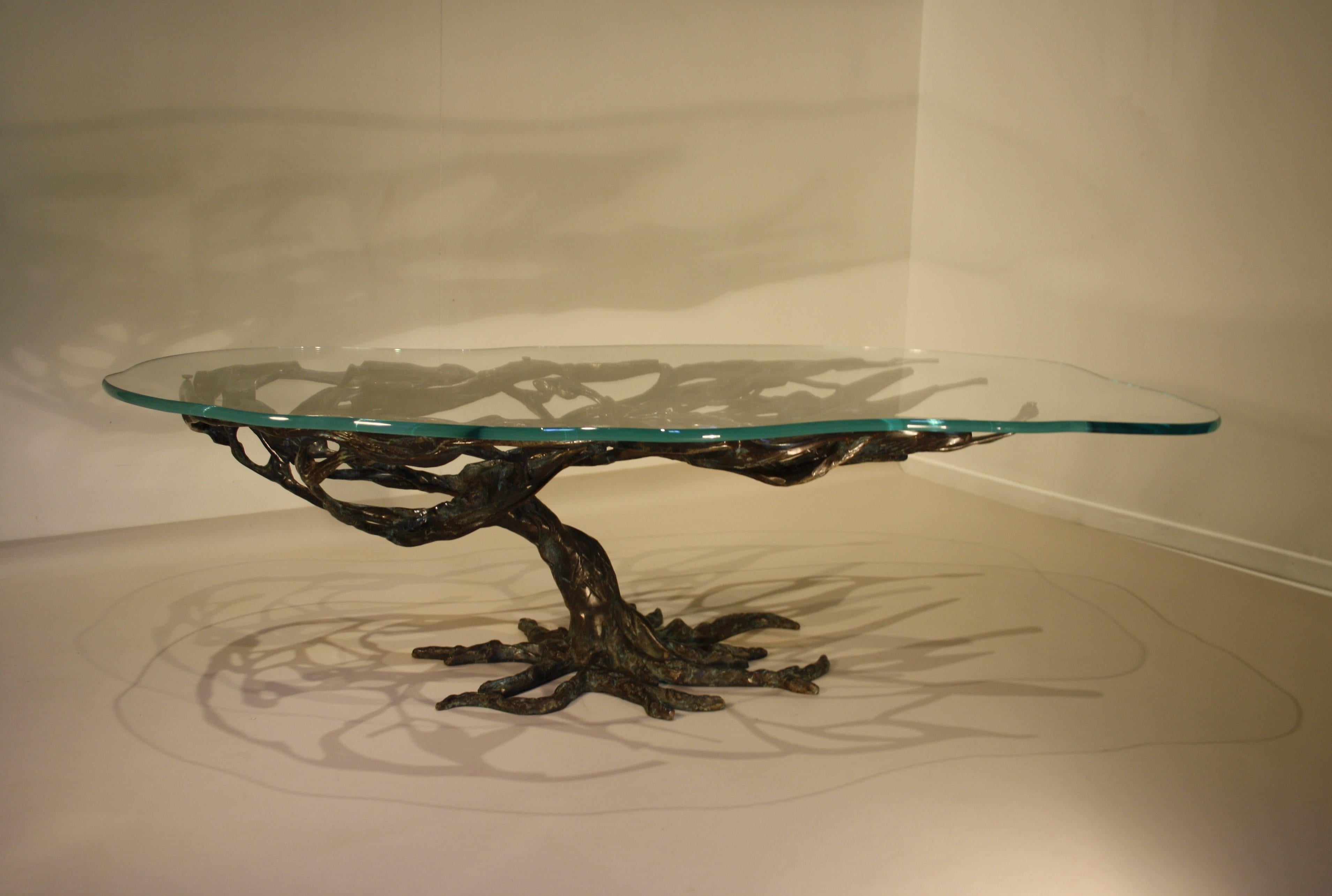 A unique cast bronze coffee table in the shape of a tree with an exceptionally beautiful dark green patina.
This patina is similar to that used by well-known artists such as Alberto Giacometti and other contemporaries
The thick tabletop has an