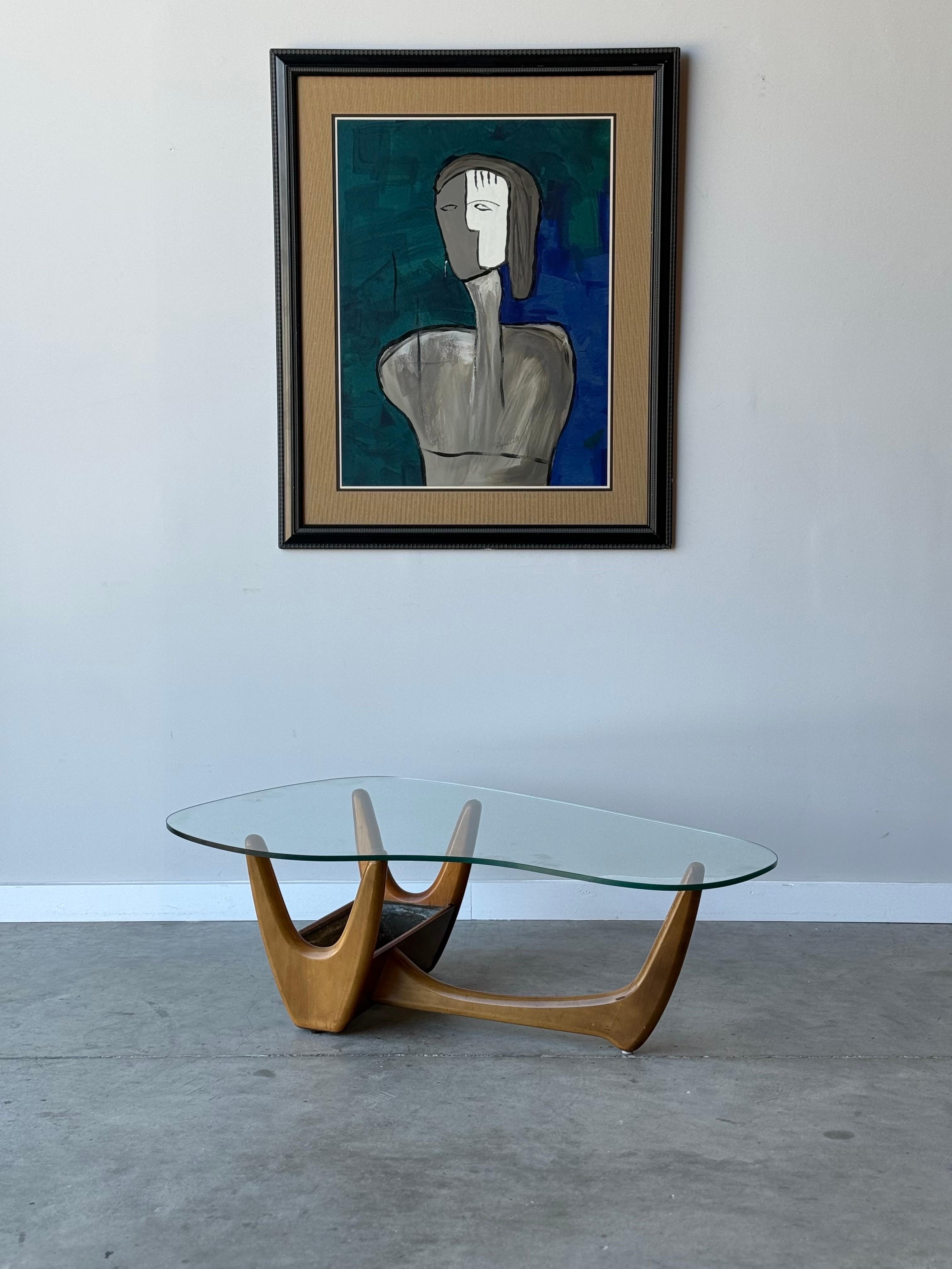 Mid-century wooden coffee table with glass top and internal planter box. This coffee table checks a lot of boxes. A sculptural wooden base supports the table top. There is an internal planter box within the base, I’m looking at you plant lovers. The