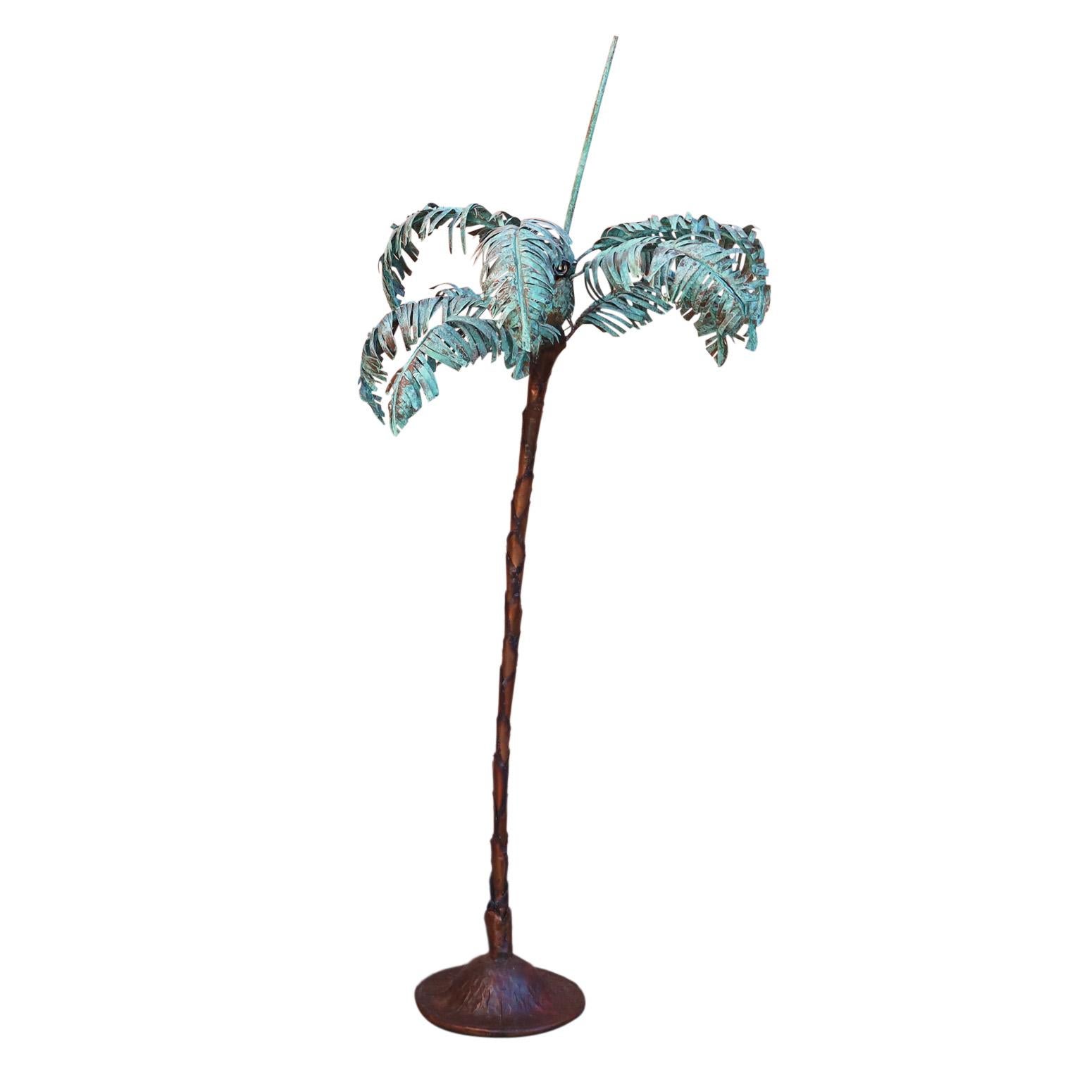 Vintage palm tree floor lamp handcrafted in copper with sculptural and brutalist influences featuring verdigris copper patina palm leaves, four bulb sockets, stylized layered copper trunk and hammered multi patina base.