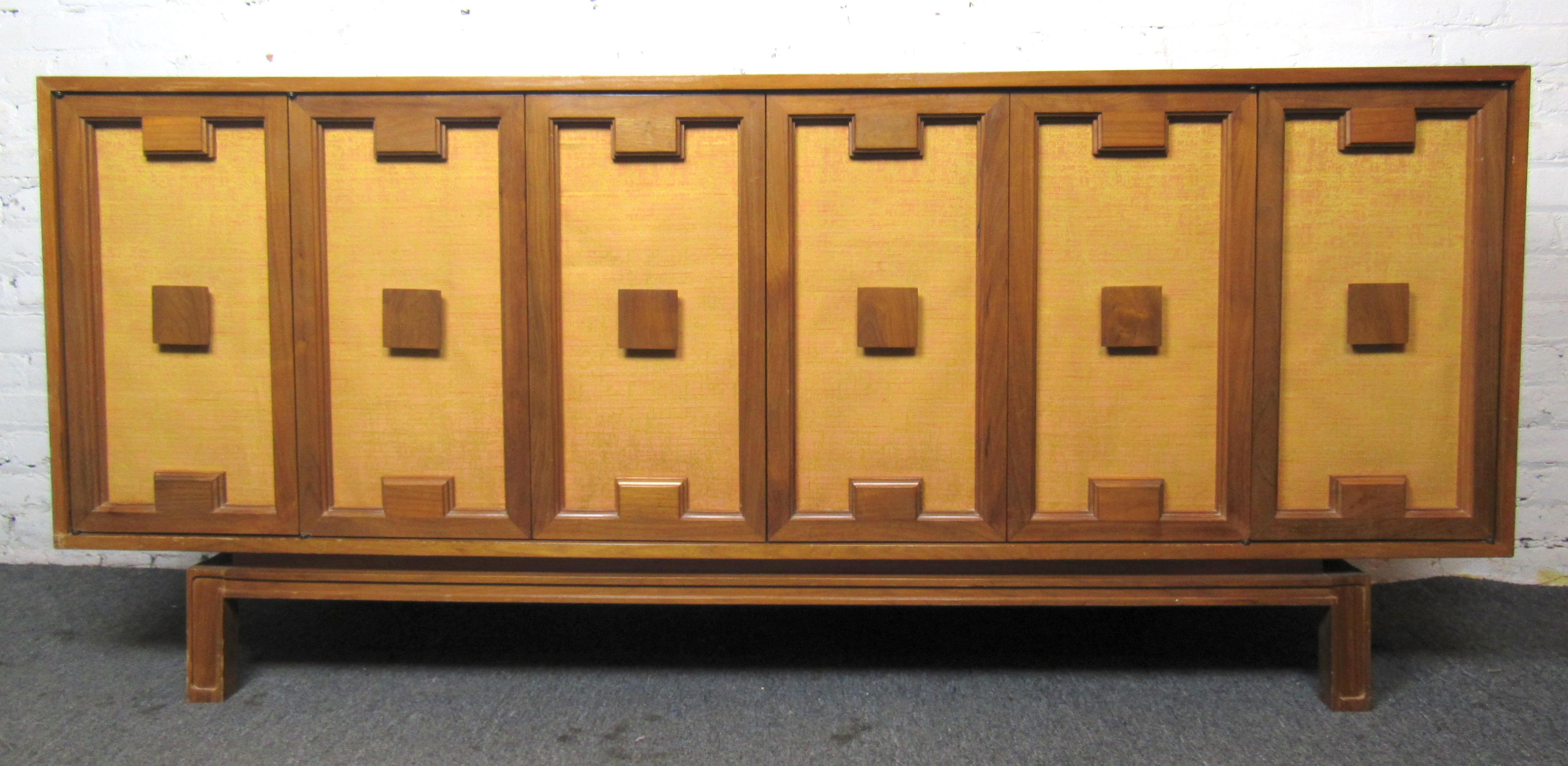 Long credenza with walnut grain, sculpted front and cloth backing. Ample storage space with adjustable shelves.
(Please confirm item location - NY or NJ - with dealer).
 