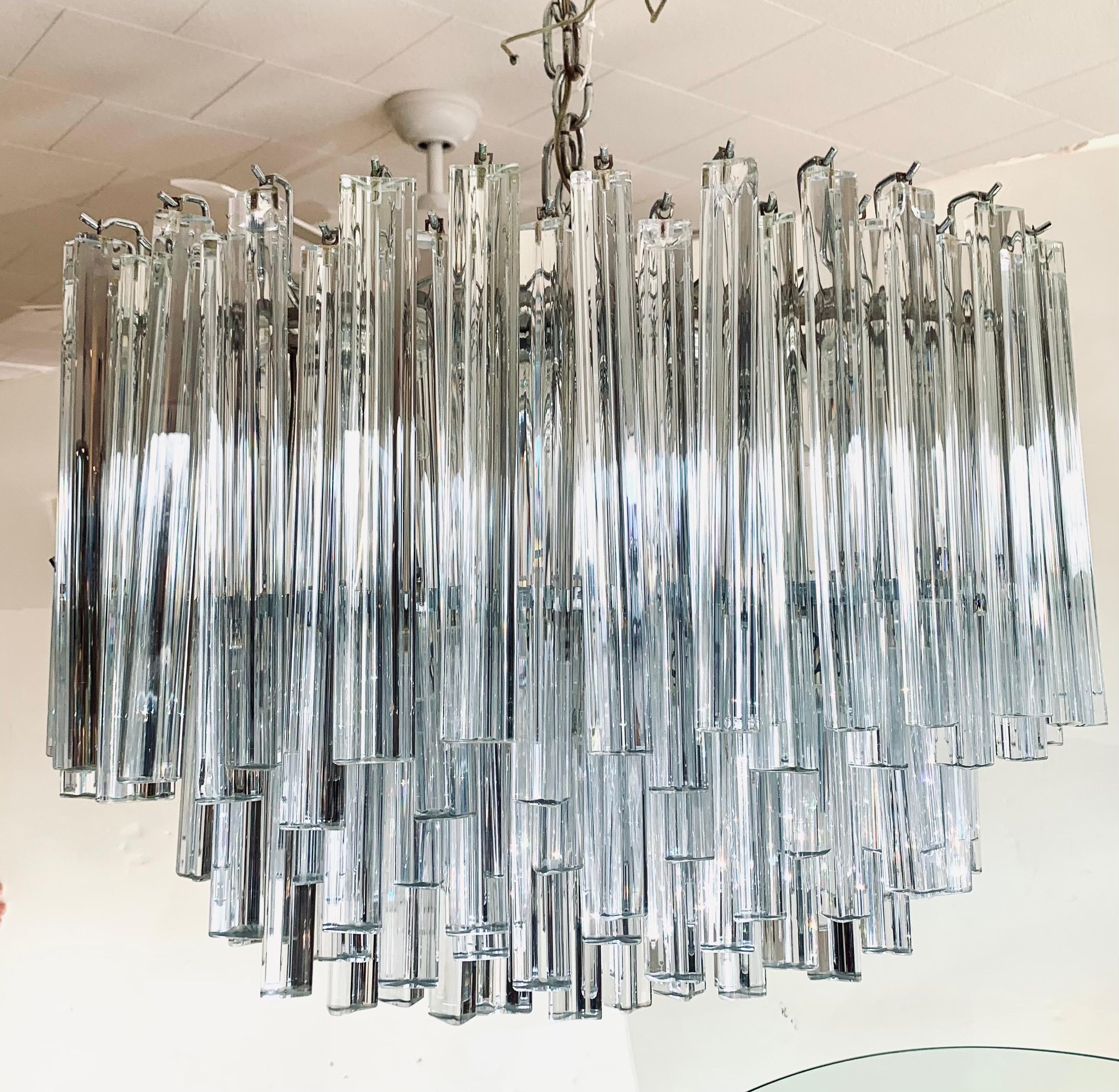 A magnificent Murano glass chandelier made by Camer. Comprised of individually handblown Murano glass triangular triede crystal prisms on a frame. An iconic and timeless classic. Note the oval curvature. Features eight lights.