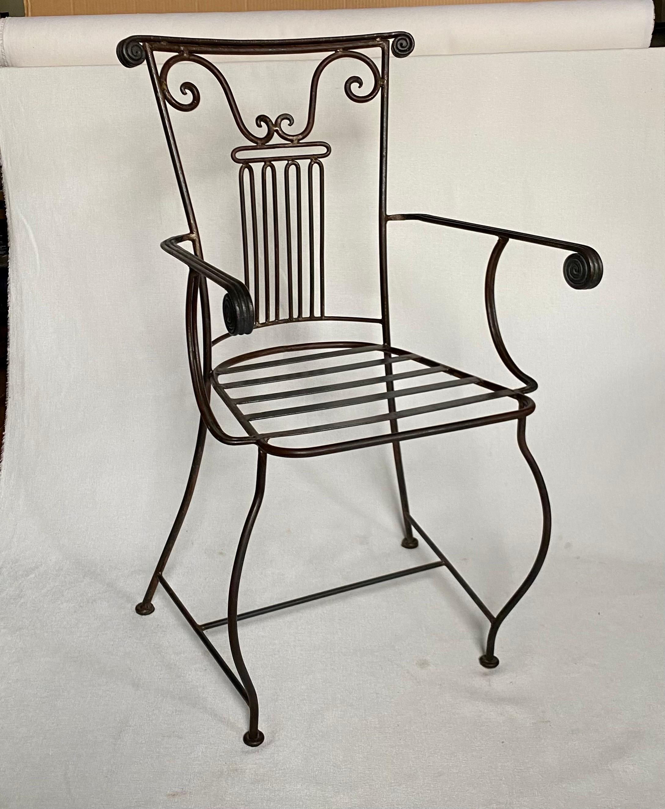 Sculptural Neoclassical style Roman column form iron accent armchair with decorative scrolls and flared cabriolet legs.  This stylized chair makes a perfect accent or desk chair.  Top with a seat cushion of your choosing.  

Arm Height: 26.5 Inches. 