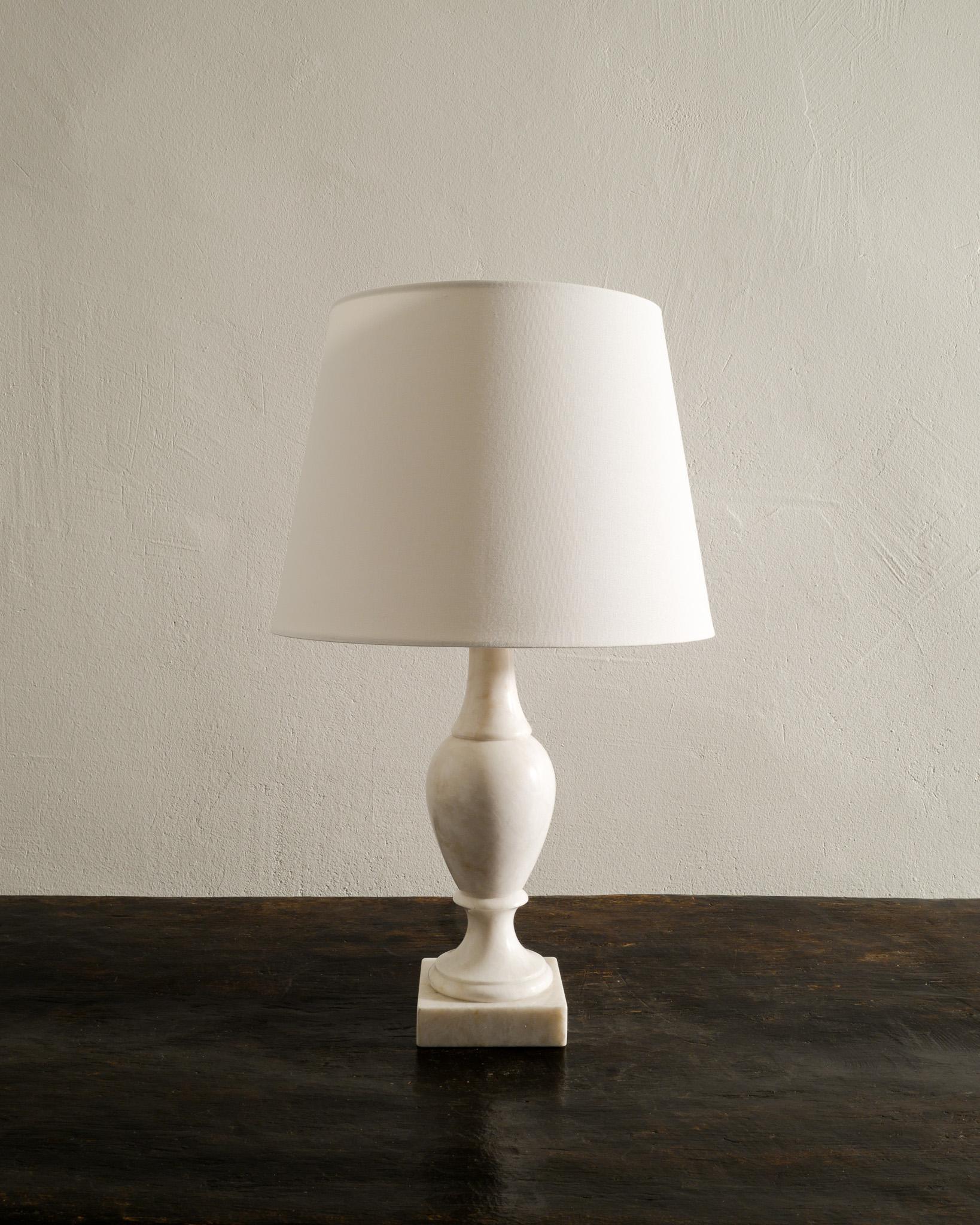 Beautiful mid century desk / table lamp in solid white marble by anonymous designer probably produced in Sweden around 1960s. In great original condition with minimal signs of age and use. Newer wiring. 
Shade is not included in the purchase.