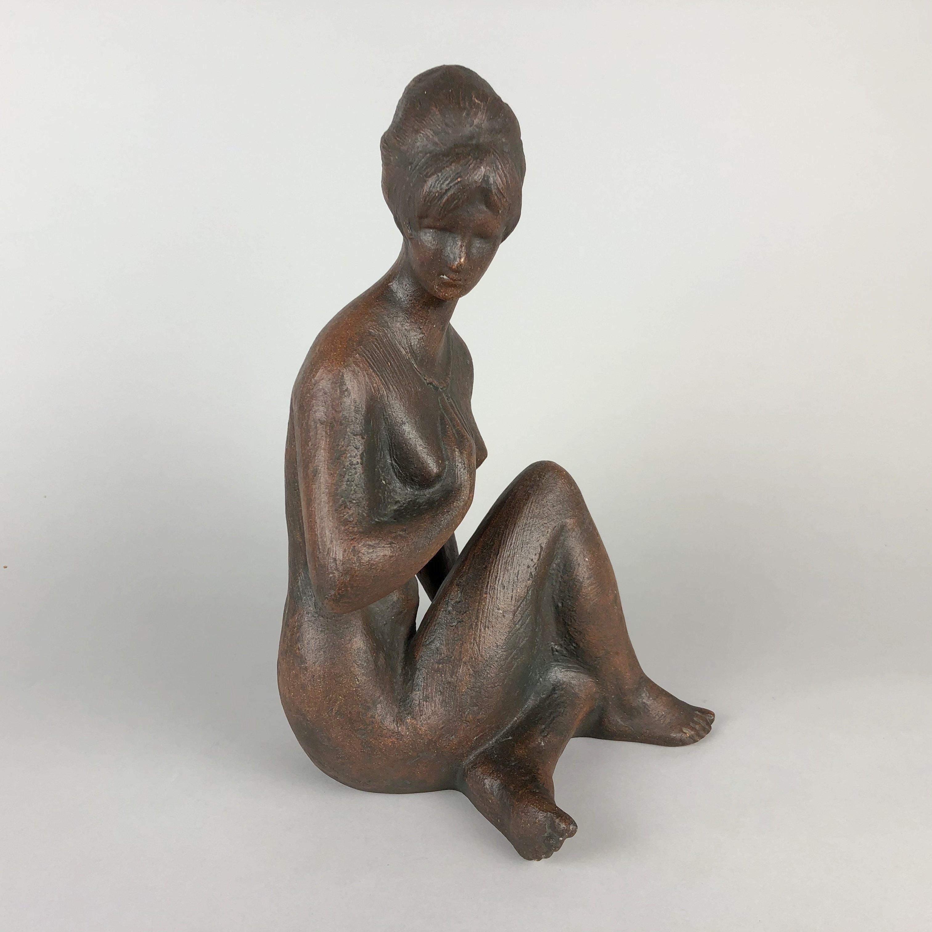 Beautiful patinated ceramic statue designed by Bohumil Kokrda in 1967 and produced by Jihokera Bechyne in former Czechoslovakia. The statue of a nude sitting women is in good vintage condition.