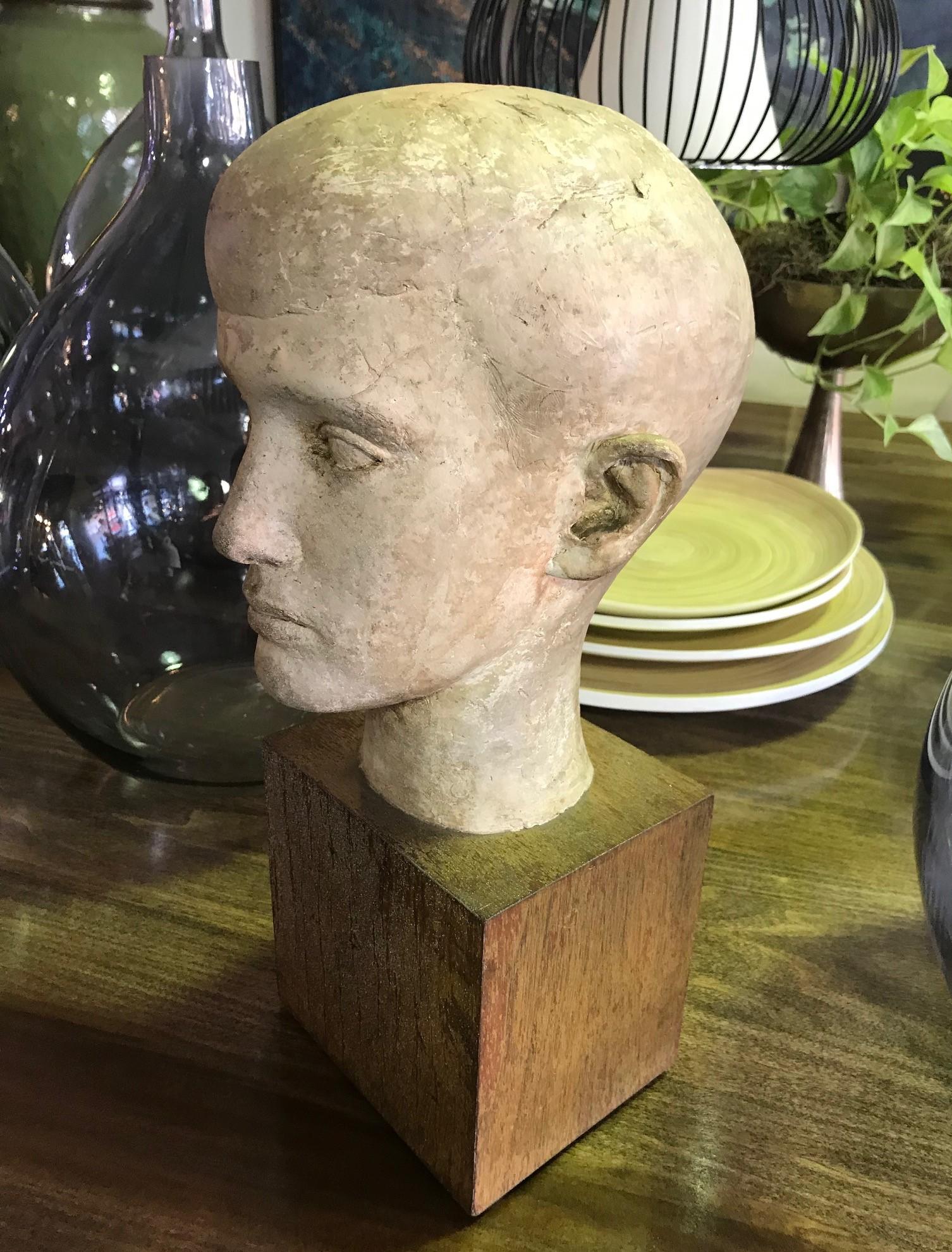 A very well-done midcentury piece. Solid and heavy on a sturdy wood base. 

Dated 