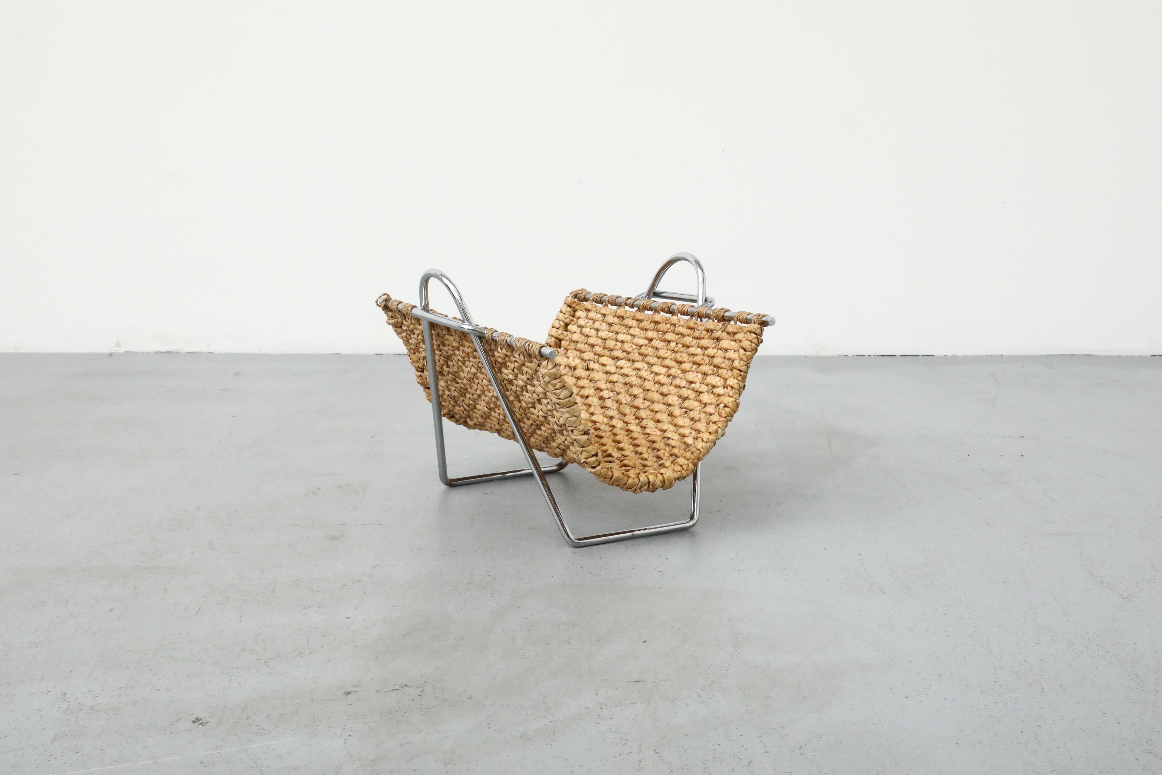 Actually incredible! This Mid-Century rack has a beautiful seagrass basket in a tubular chrome frame. Easily removable from its frame to tote newspapers, logs, or flowers, even!  In original condition with wear consistent with age and use.