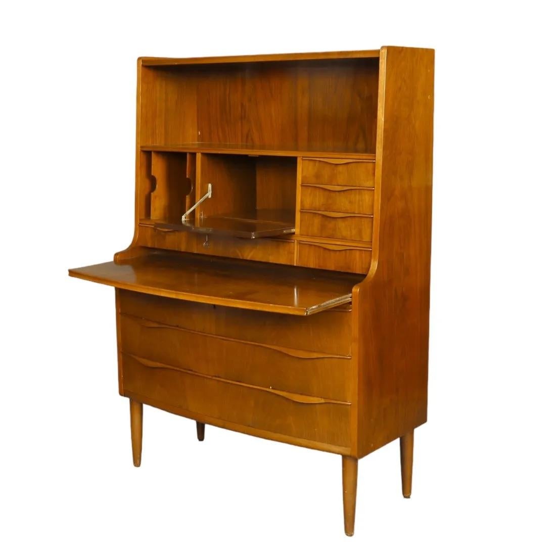 Beautiful Mid-century Teak dresser with a pull out desk option. 
beautiful craftsmanship and detail featuring many storage areas and 3 large drawers on the bottom.  this piece was made in Denmark early 1960's and very good condition considering use