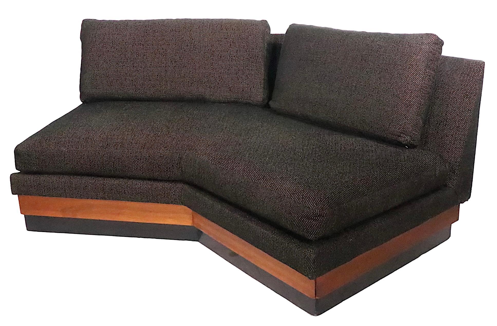 Architectural two piece sectional sofa, designed by Adrian Pearsall for Craft Associates. The sofa features an angled section, which has a storage cabinet on its end, with a drop down door cover. The other section is straight, making it possible to