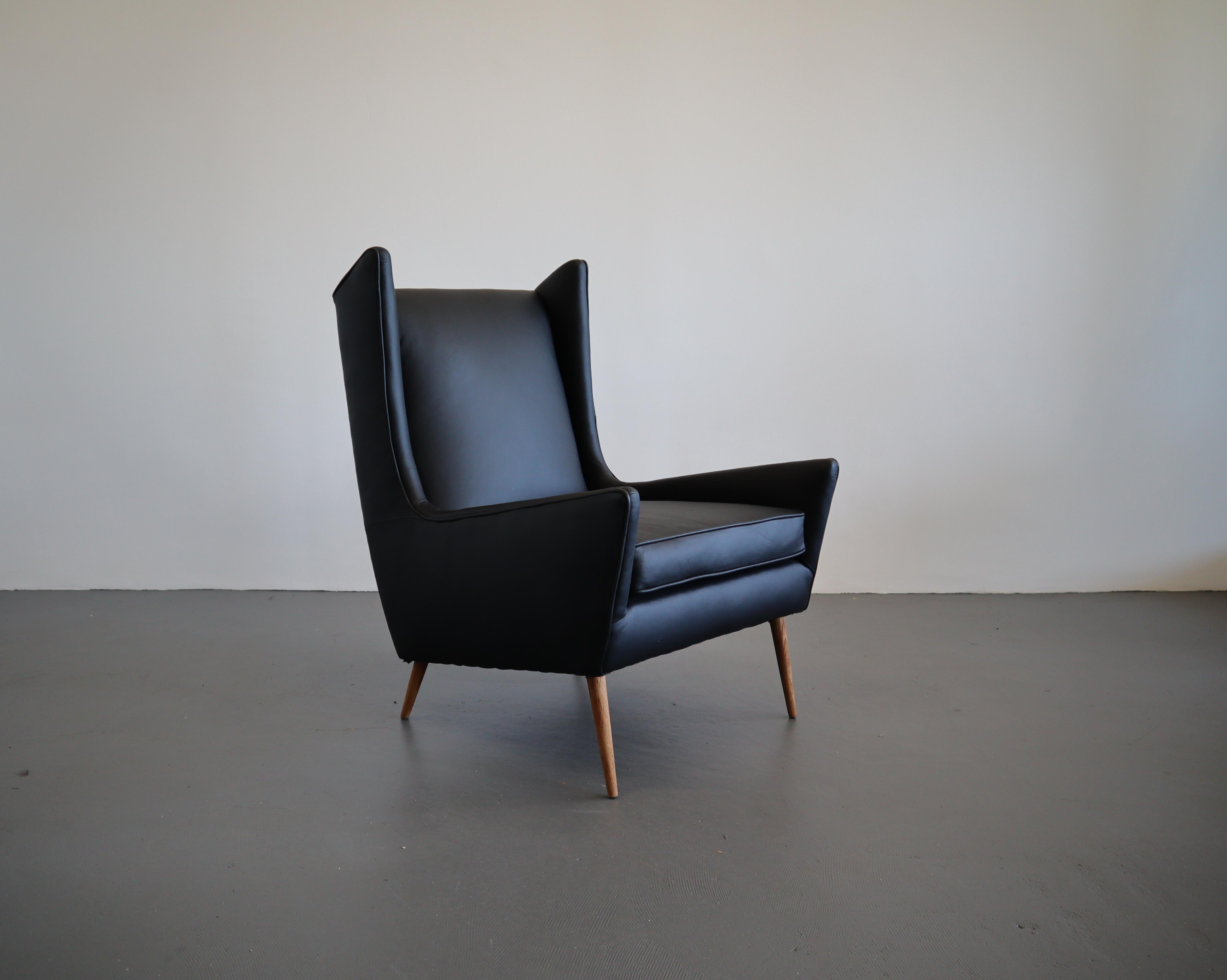 Classic Mid Century design at its best, this newly reupholstered wing back chair for Selig is a rare find. Sleek tapered walnut legs are a nod to an iconic era of the past. Cool angular lines slope and intersect effortlessly for deep lounge seating.