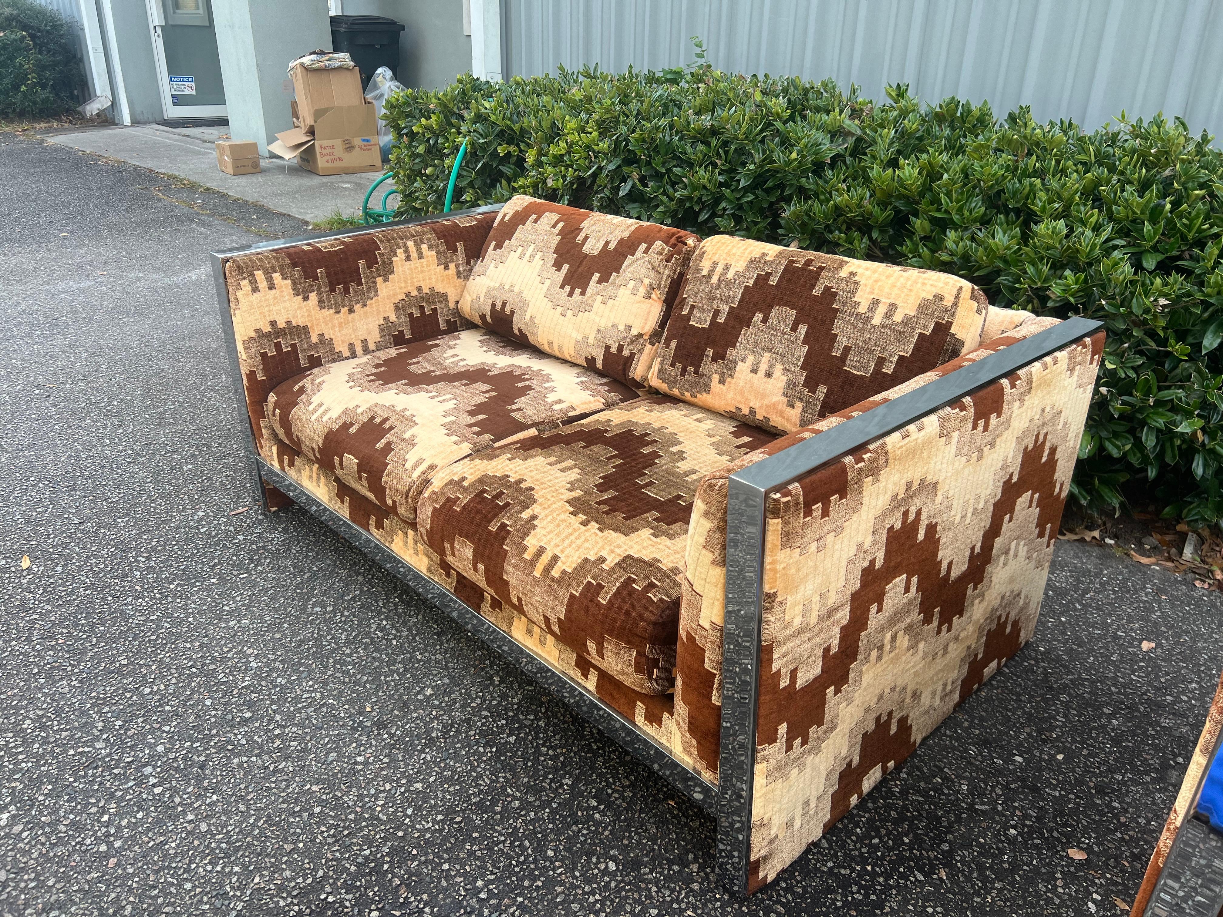 A stunning mid-century modern loveseat Milo Baughman style, by Selig Monroe in original soft chevron pattern upholstery, flat bar polished chrome case frame. Chrome in excellent condition. An exceptional loveseat both for its form and quality, it is