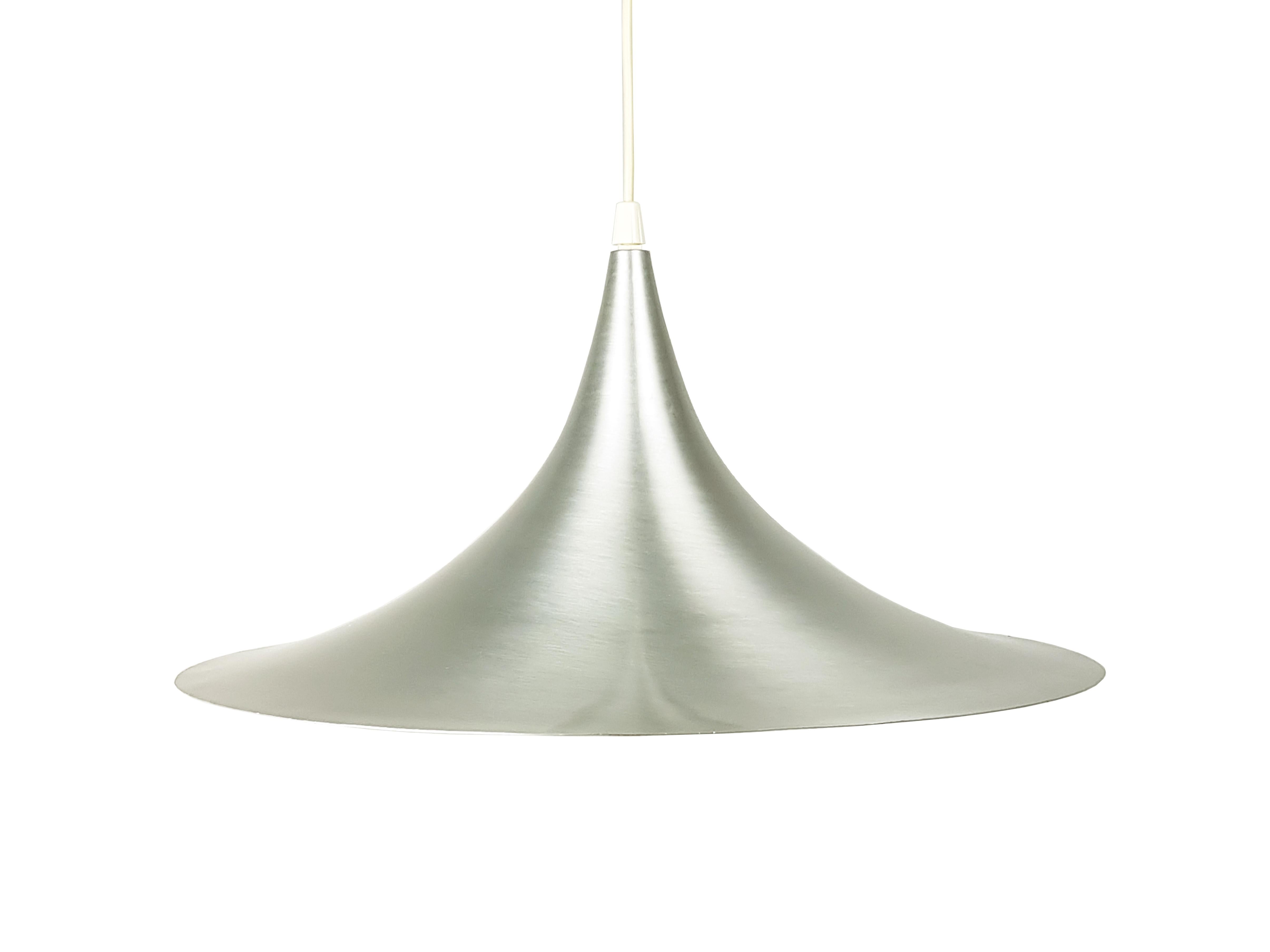 Semi pendant lamp by Claus Bonderup & Torsten Thorup, Denmark, 1967. Based on two quarter-circles - back-to-back. It is made from brushed aluminum. 
Adjustable height.
Measures: overall height cm 130 (the cable can be shortened)
diameter: cm