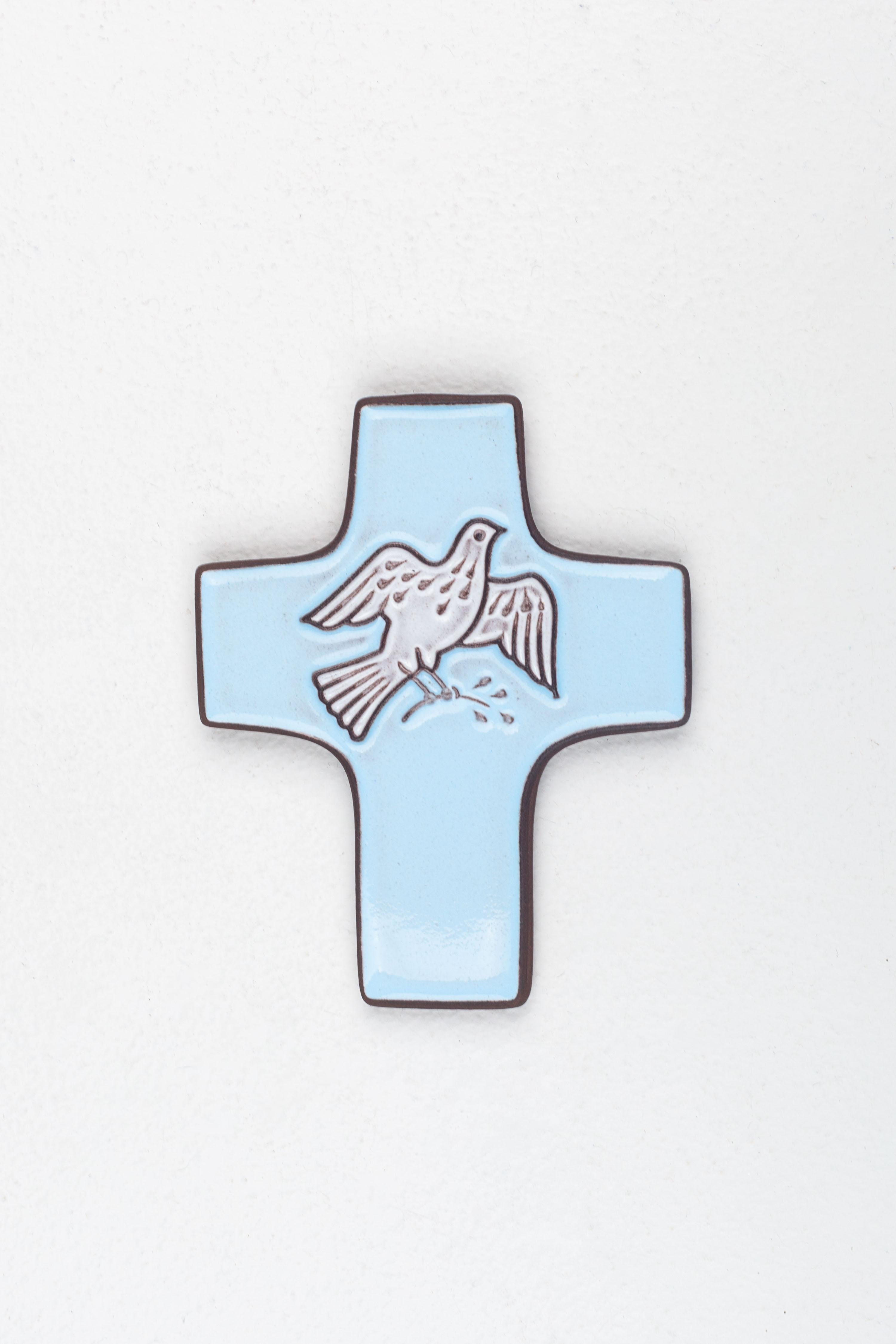 This serene ceramic cross is a distinguished example of mid-century modern studio pottery from Europe. Embodying the innovative spirit of that era, it features the peaceful figure of a dove in relief, a symbol traditionally associated with the Holy