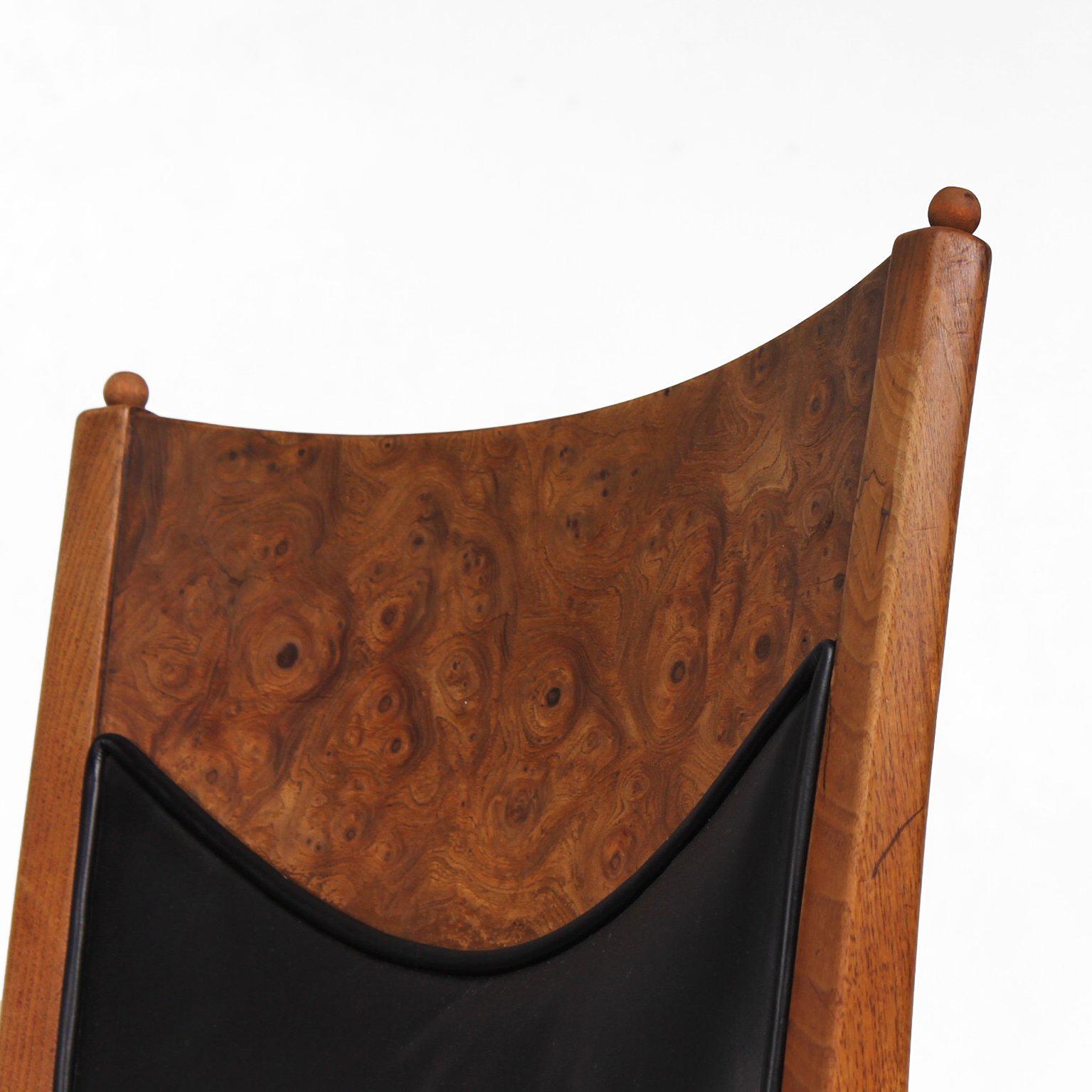 For your consideration a set of four dining chairs. Constructed with solid walnut wood frame and burl wood bent plywood/veneer in back rest. The seat and back rest is upholstered with the original black leather which is decorated with golden starts.