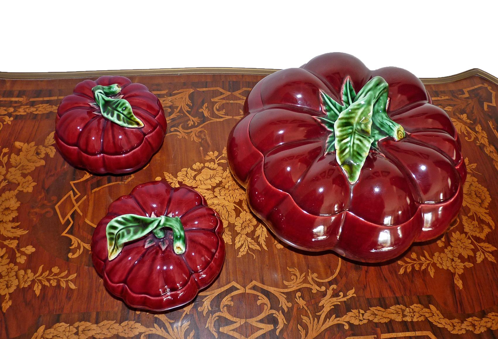 Gorgeous set hyper realistic glazed ceramic red tomato covered tureen and a pair of sugar jam bowl in shades of red and green with dark accents manufactured in Portugal, 1950s. Beautiful to use as a decoration. A beautiful example of the traditional