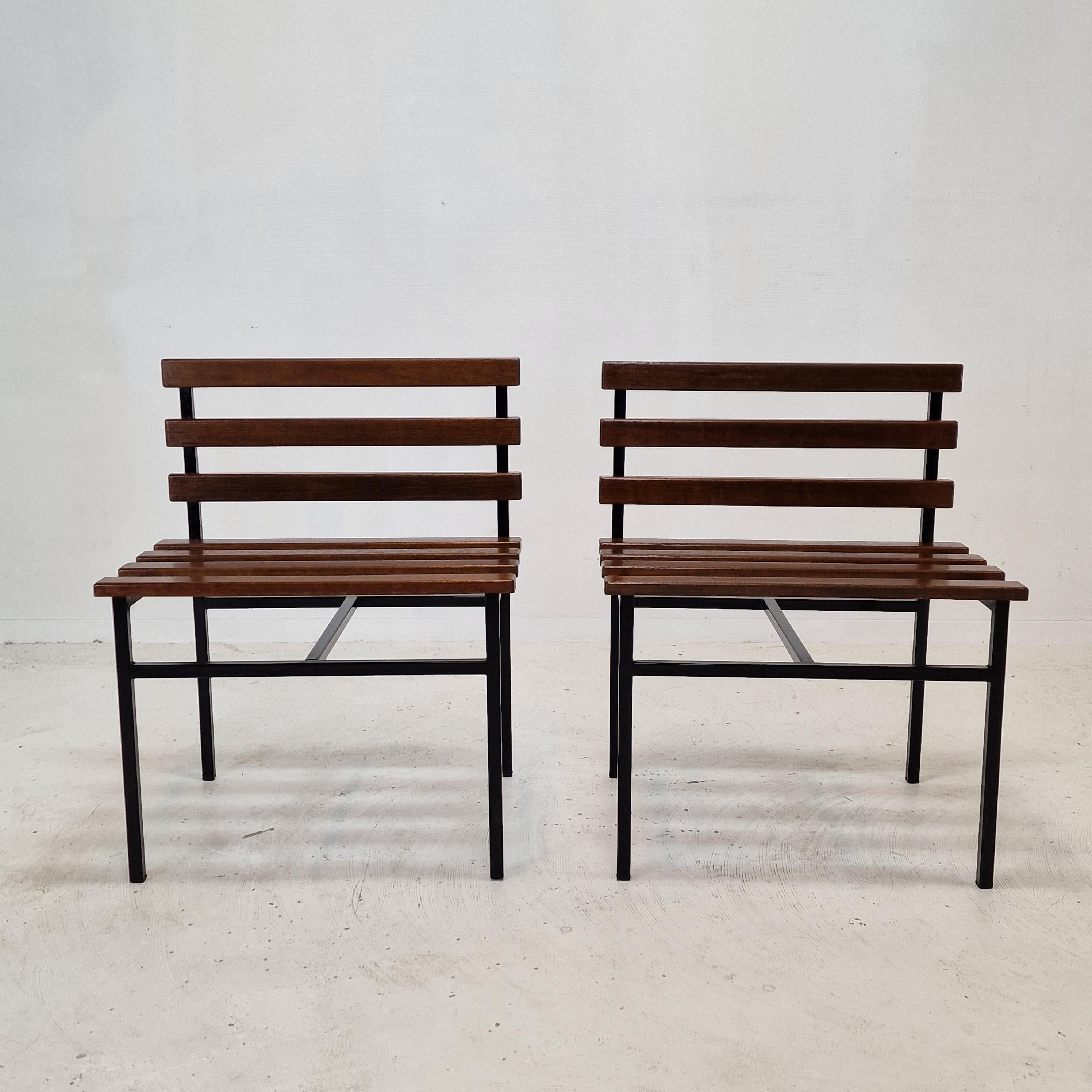 Very nice set of 2 Italian benches or chairs.
They are made in the 1960s. 

Teak wooden seating with a black metal structure.

We work with professional packers and shippers, we can deliver in 5 to 10 days.