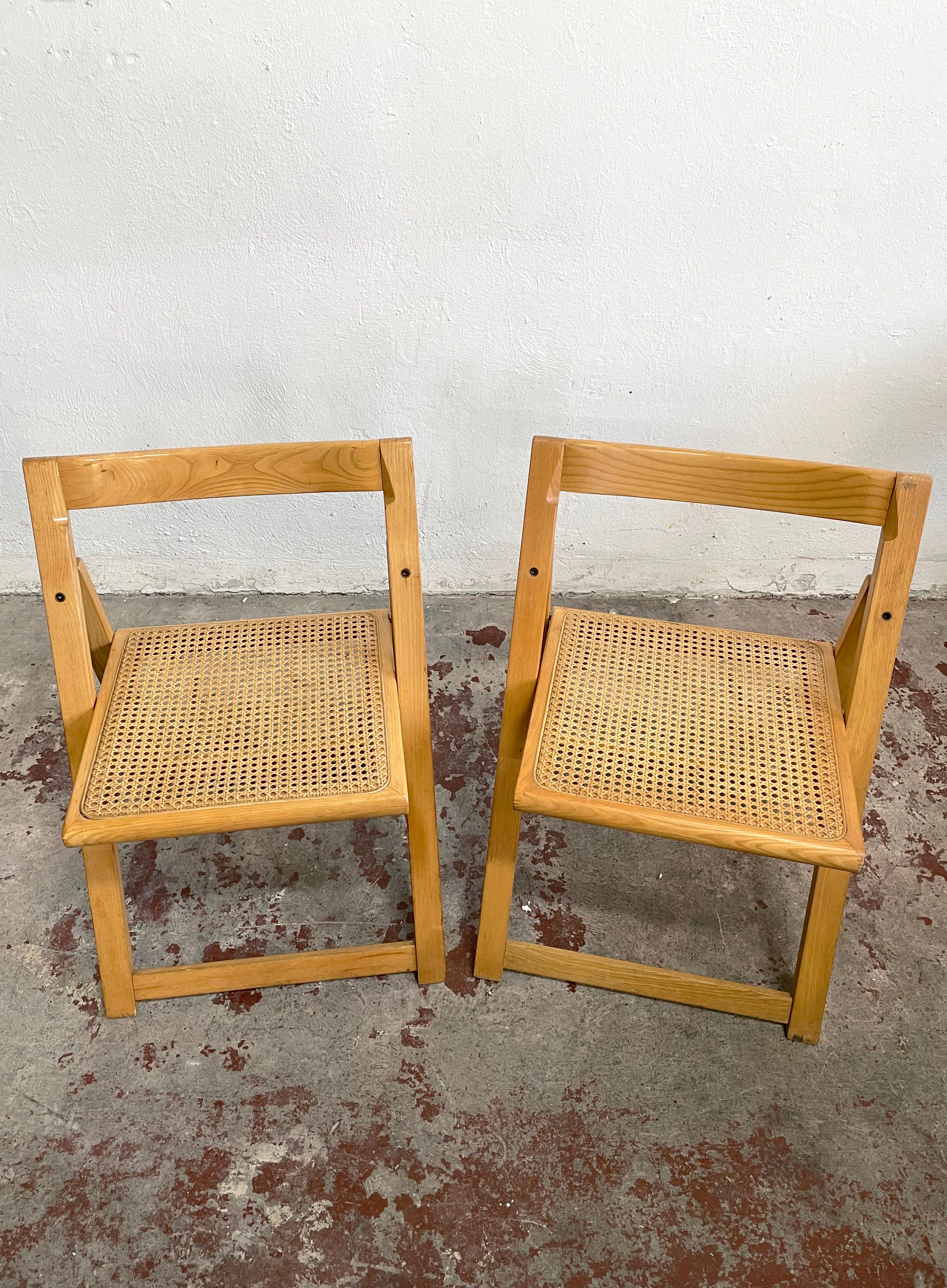 Offered for sale is a set of 2 vintage Italian folding chairs

The chairs are made of solid wood (beech) frame and cane seat

The chairs are in the style of the famous 'Trieste' chair designed by Aldo Jacober and Pierangela d’Aniello

The year