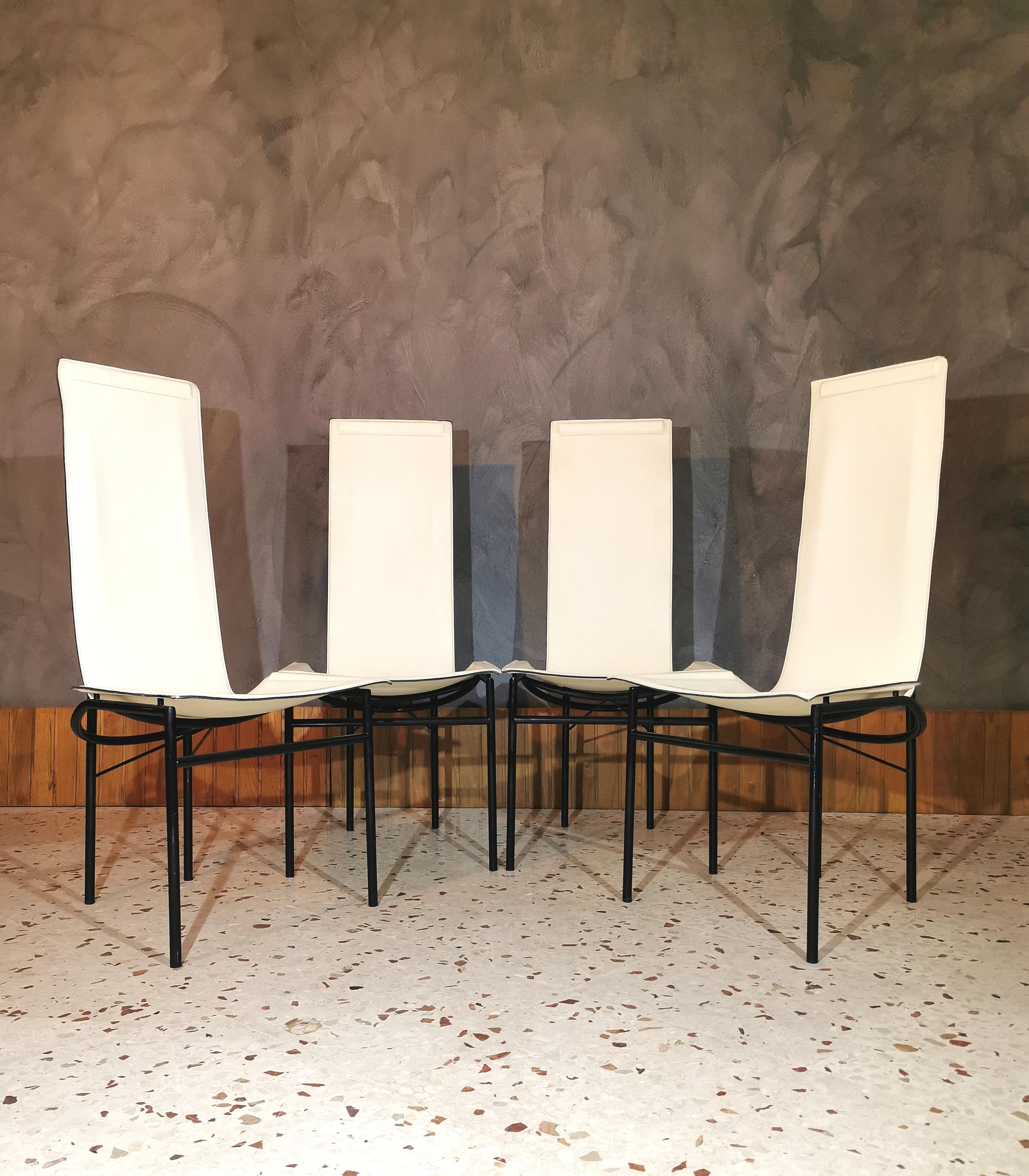 Elegant set of 4 lounge / dining chairs with black enamelled metal structure, covered in white leather. Made in Italy in the 1980s.