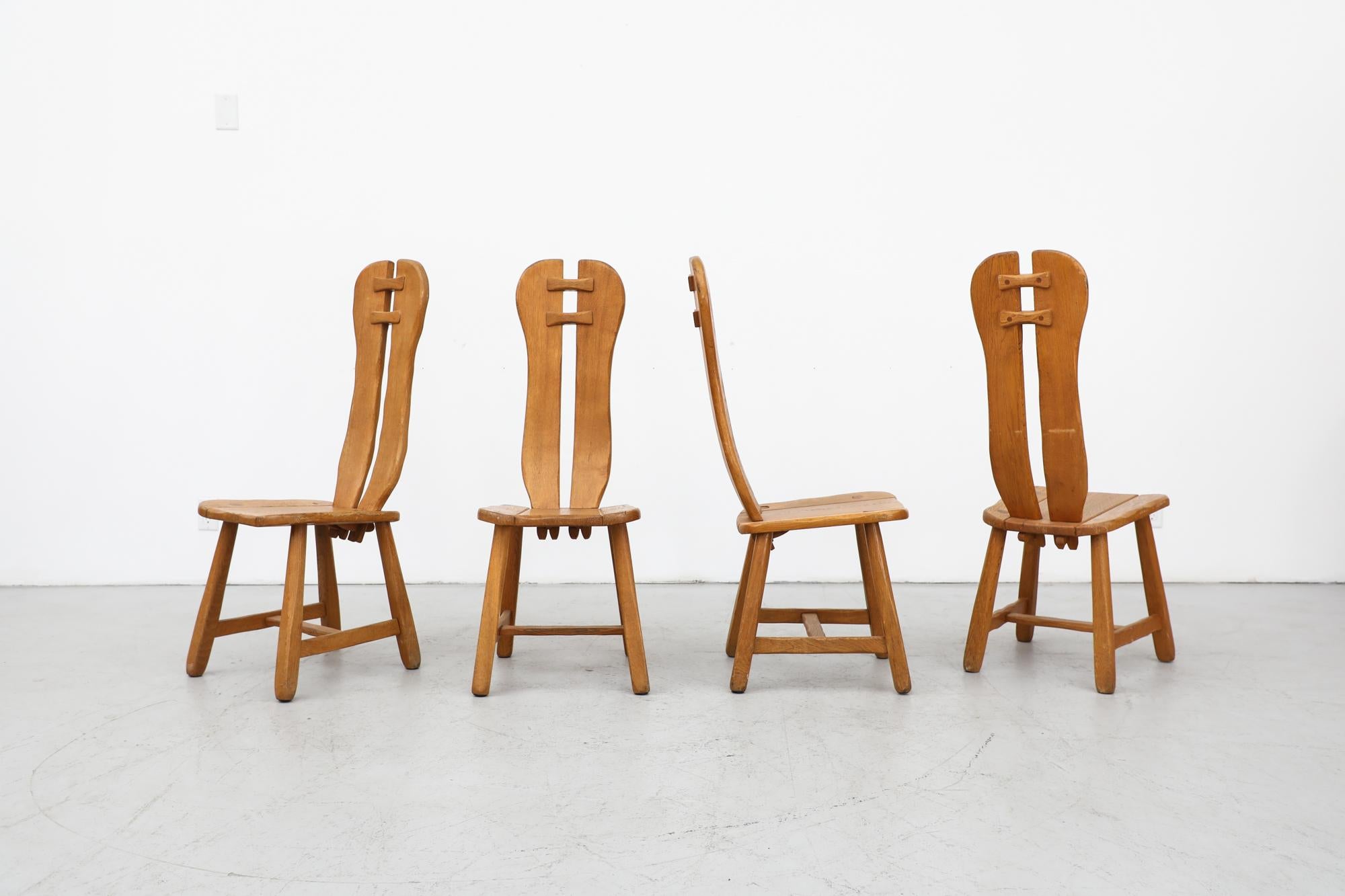 Set of 4 high back brutalist dining chairs by De Puydt, Belgium. 1970's rough oak with beautiful, heavy grain and normal wear and patina appropriate for their age. In original condition with some visible cracking. Other brutalist sets of chairs are