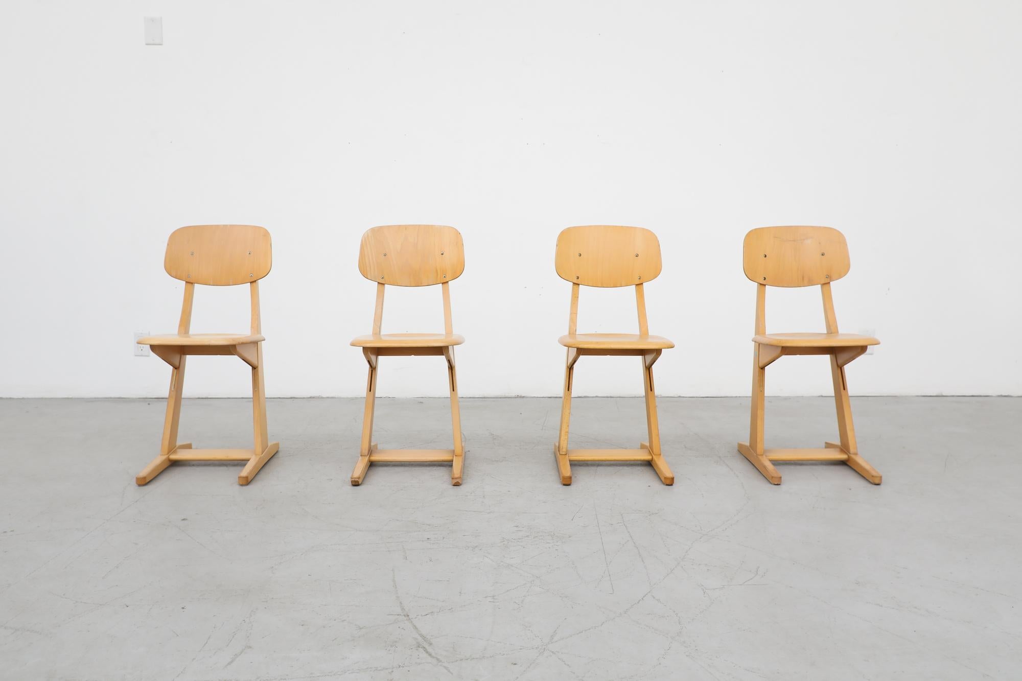 Set of 4 solid oak Casala chairs with cantilevered seats. In original condition with visible wear consistent with their age and use. Set Price.