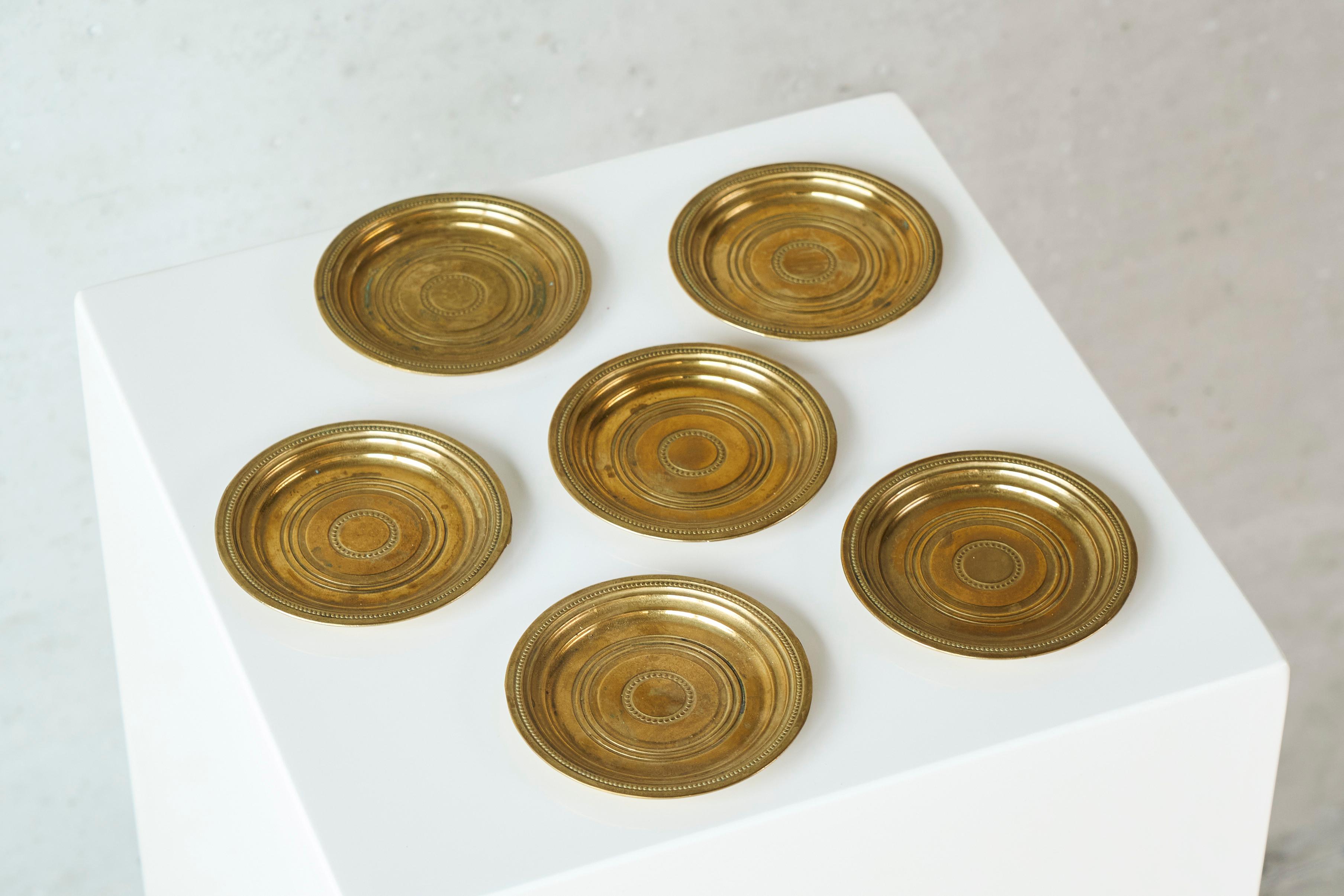 Set of 6 Coasters in Patinated Brass, Europe, Mid 20th Century.

This is a wonderful set of 6 coasters in solid brass, made in the middle of the 20th century and featuring a very nice patina. 

Great subtle yet very refined design - nice color and