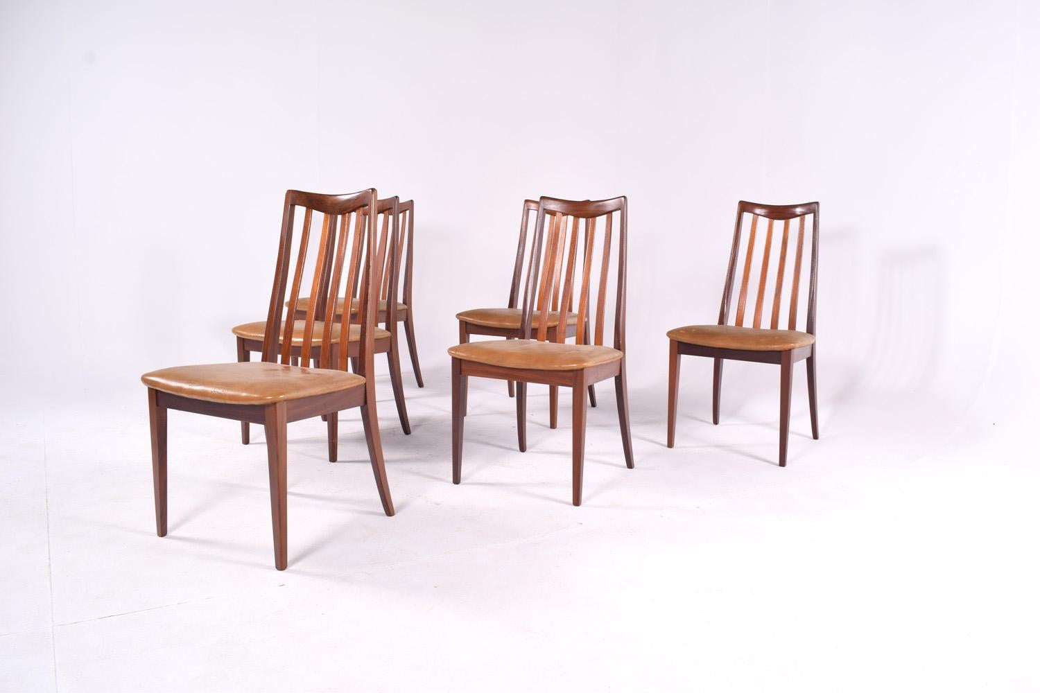A set of 6 original G-Plan dining chairs, with solid teak frames and the original brown vinyl seating with very elegant back rests.