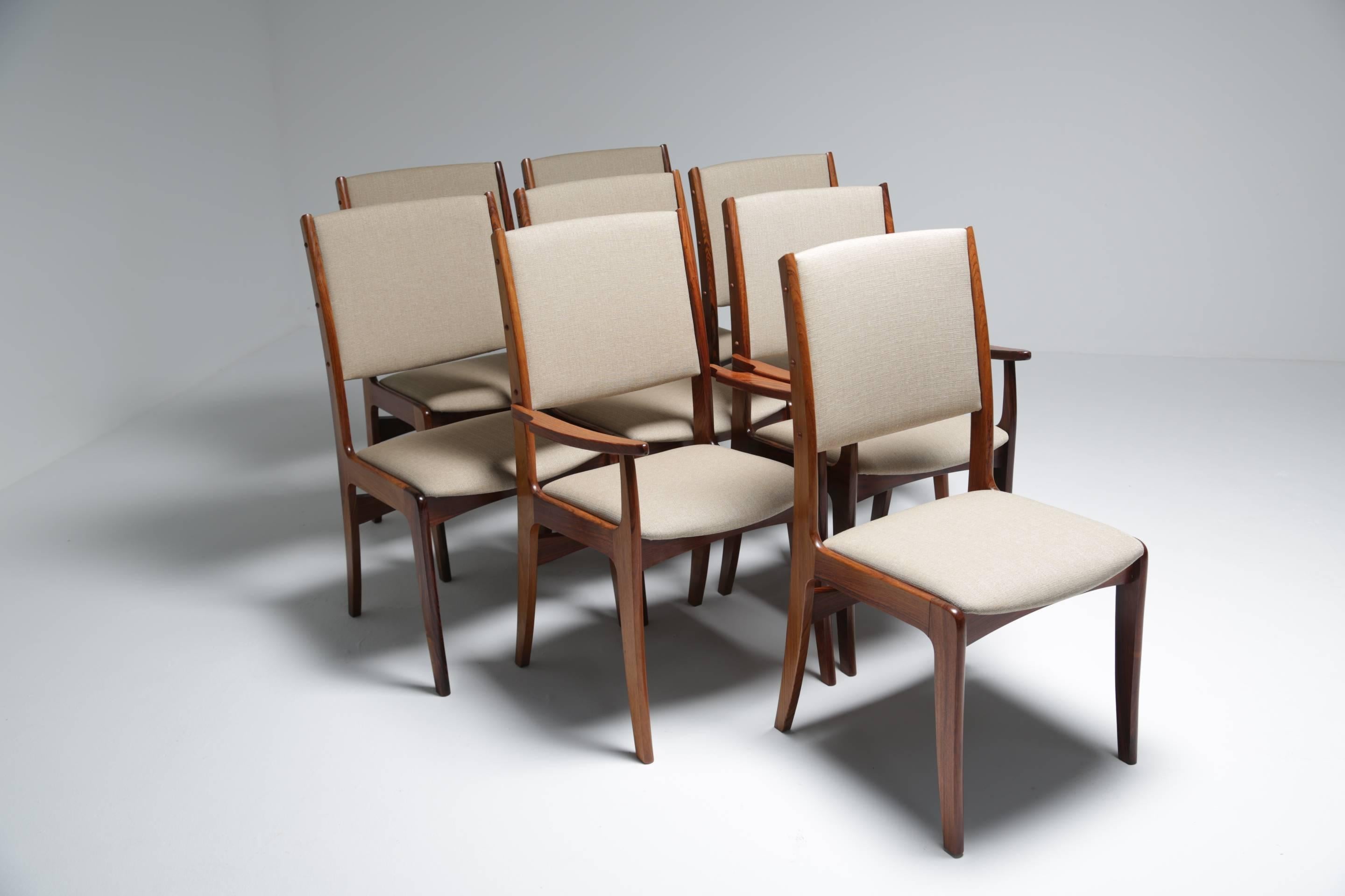 A beautiful set of eight dining chairs by renowned Danish maker Johannes Andersen for Udlum Mobelfabrik. This stunning mid-century set of chairs includes six side chairs and two carvers. All are in good vintage condition with new high quality