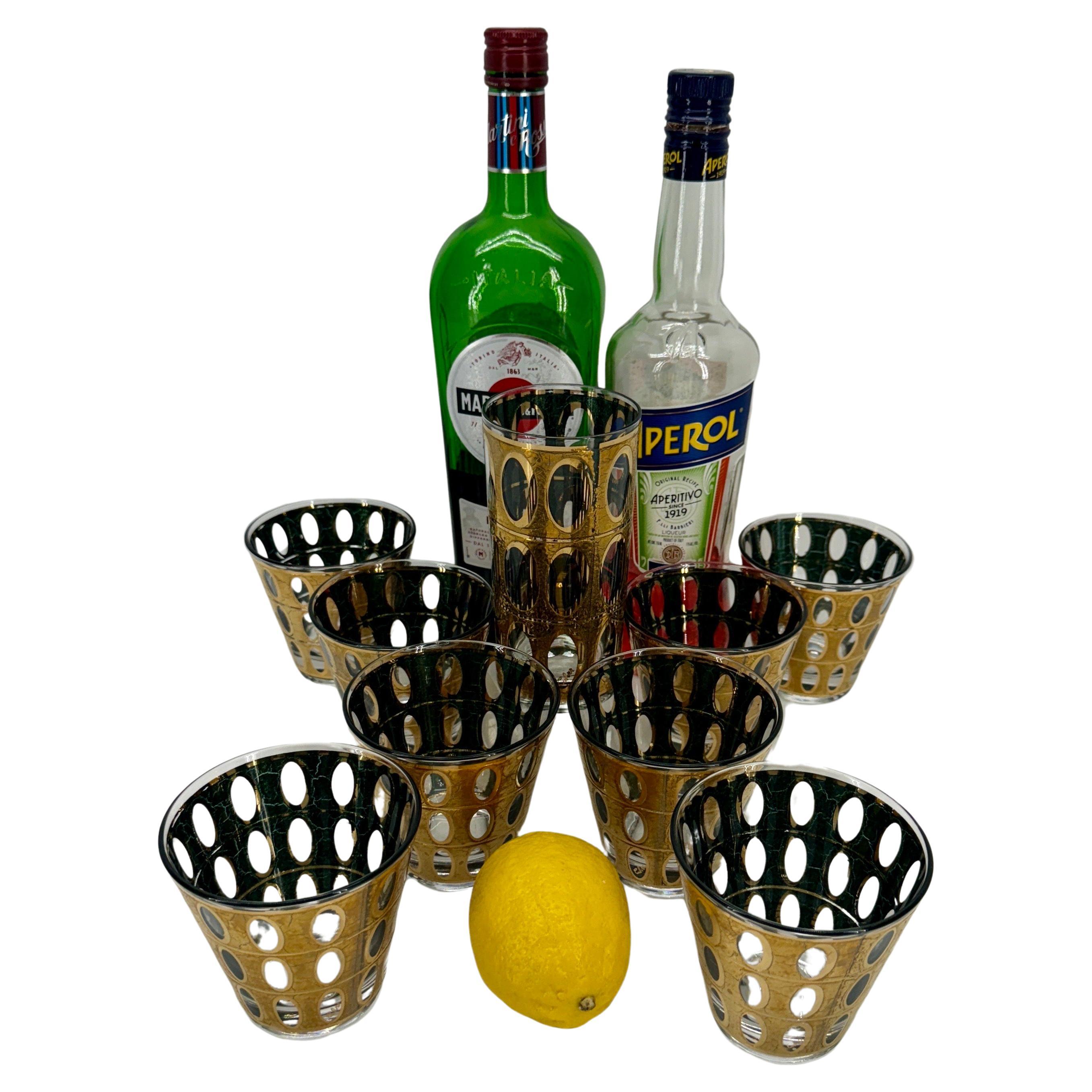 Set of 9 (8+1) Culver Pisa Gold Green Glasses

Perfect addition to your MCM Bar Cart. These vintage 22K gold textured with oval design over green are perfect for any low ball or on the rocks cocktail such as an old-fashioned. In this set are 8