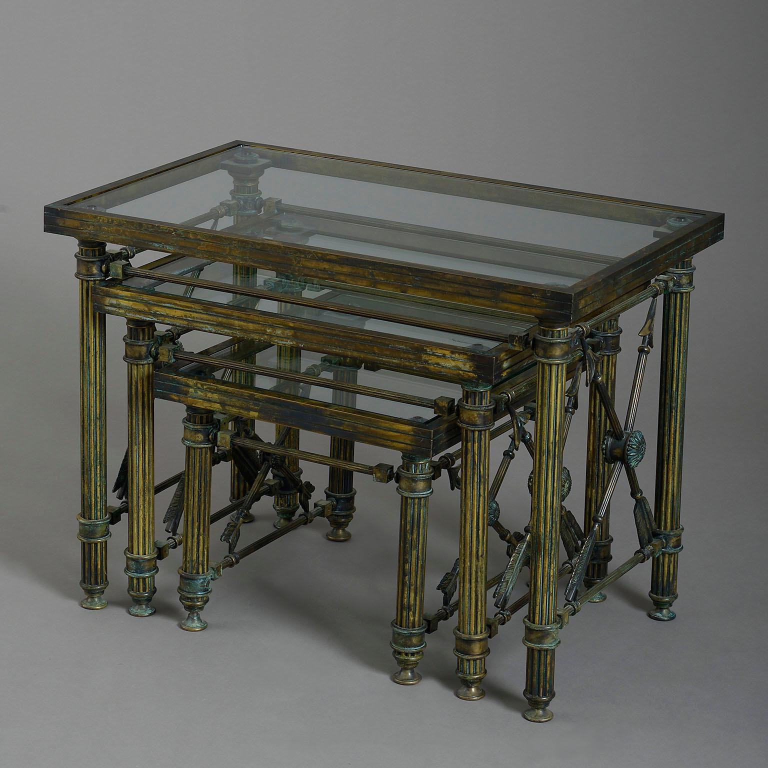 A mid-twentieth century bronzed metal nest of occasional low tables, each with a glass top and mounted on fluted legs with crossed-arrow side supports.

Circa 1950 France

Dimensions: 25.5 W x 15.75 D x 19 H inches
65 W x 40 D x 49 H cm